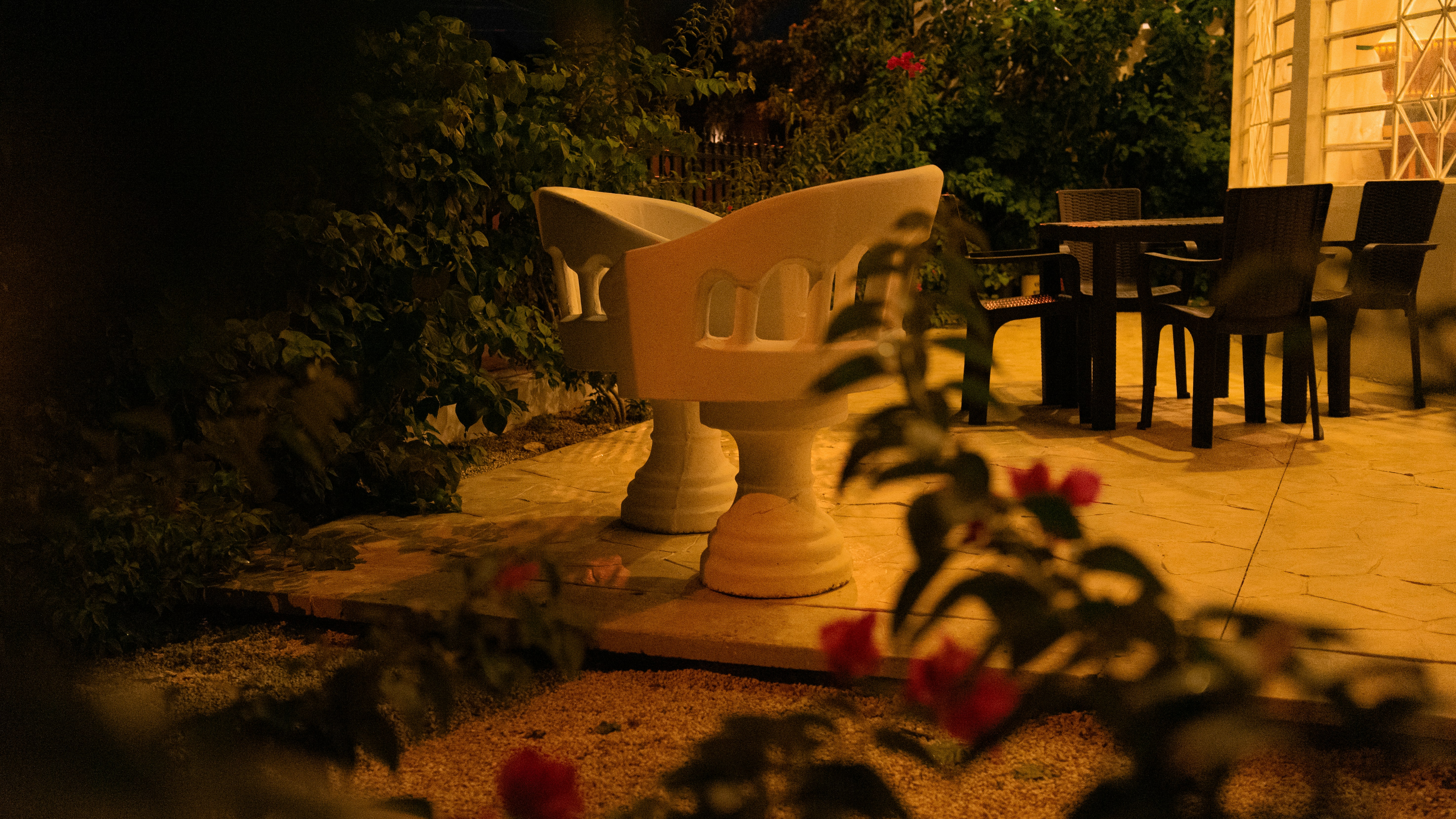 Garden patio with stone lantern and outdoor furniture at night