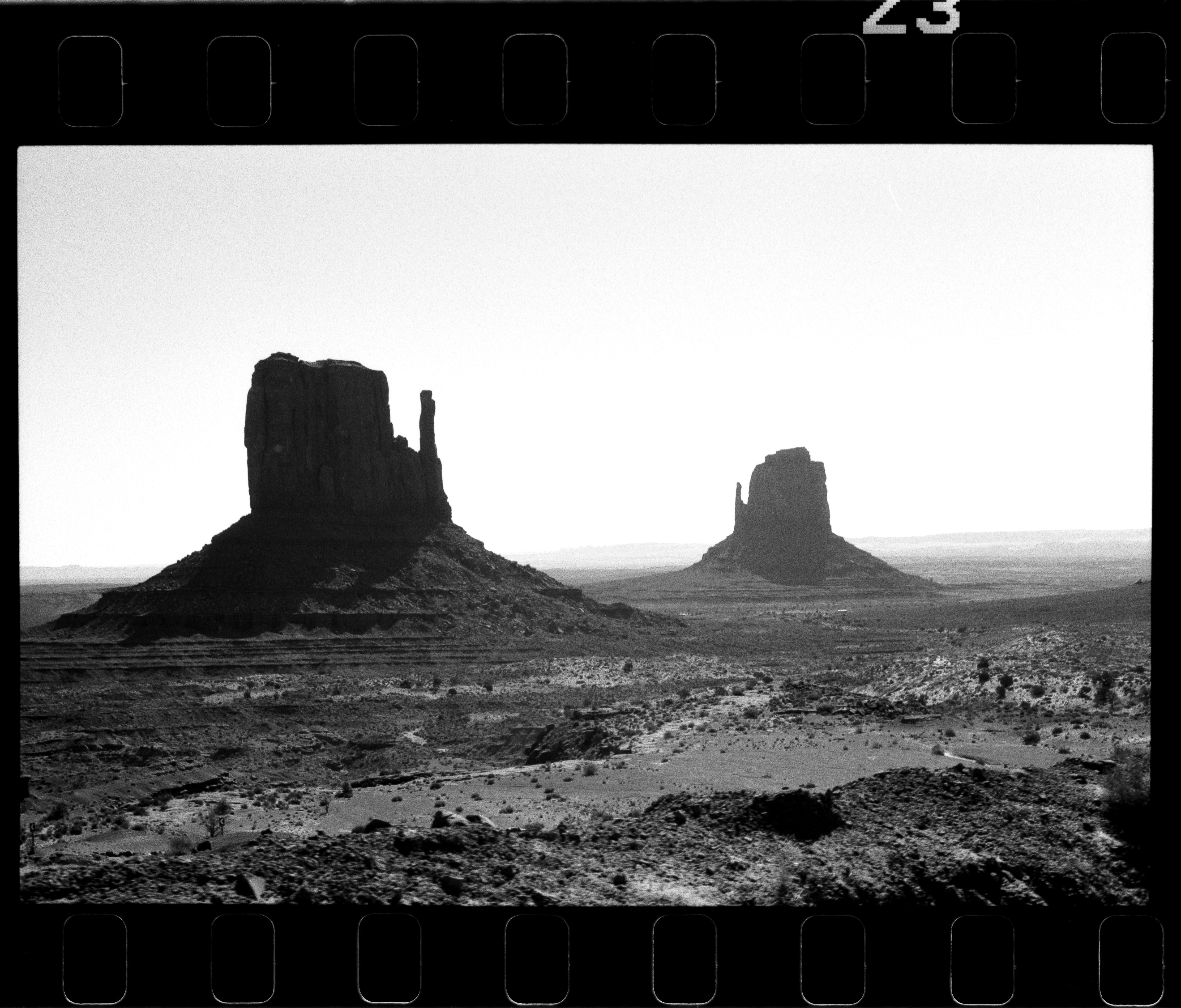 Black and white desert scene with two prominent rock formations