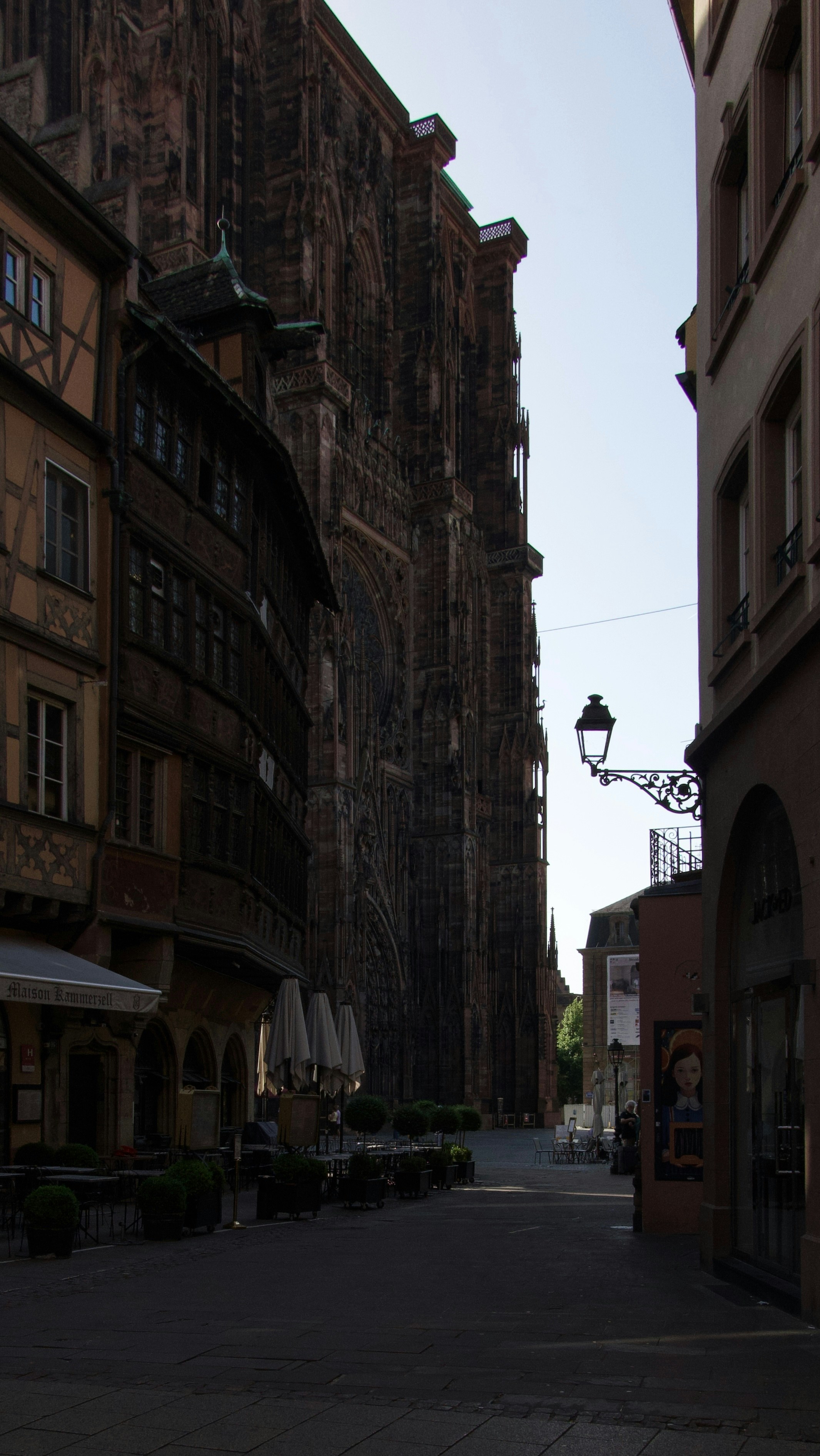 Narrow street with historic buildings and a grand cathedral