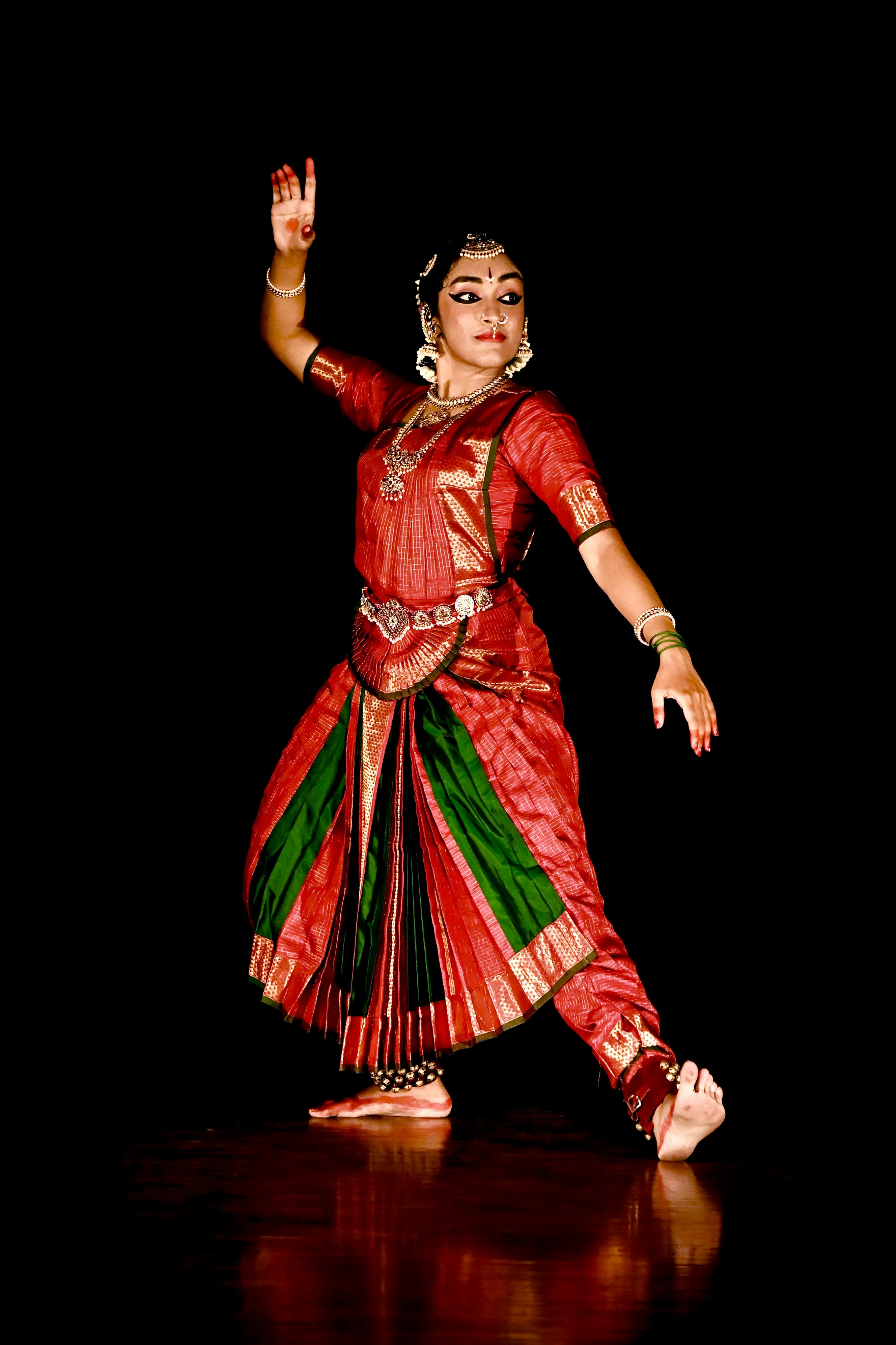 Woman performing classical indian dance in vibrant costume.