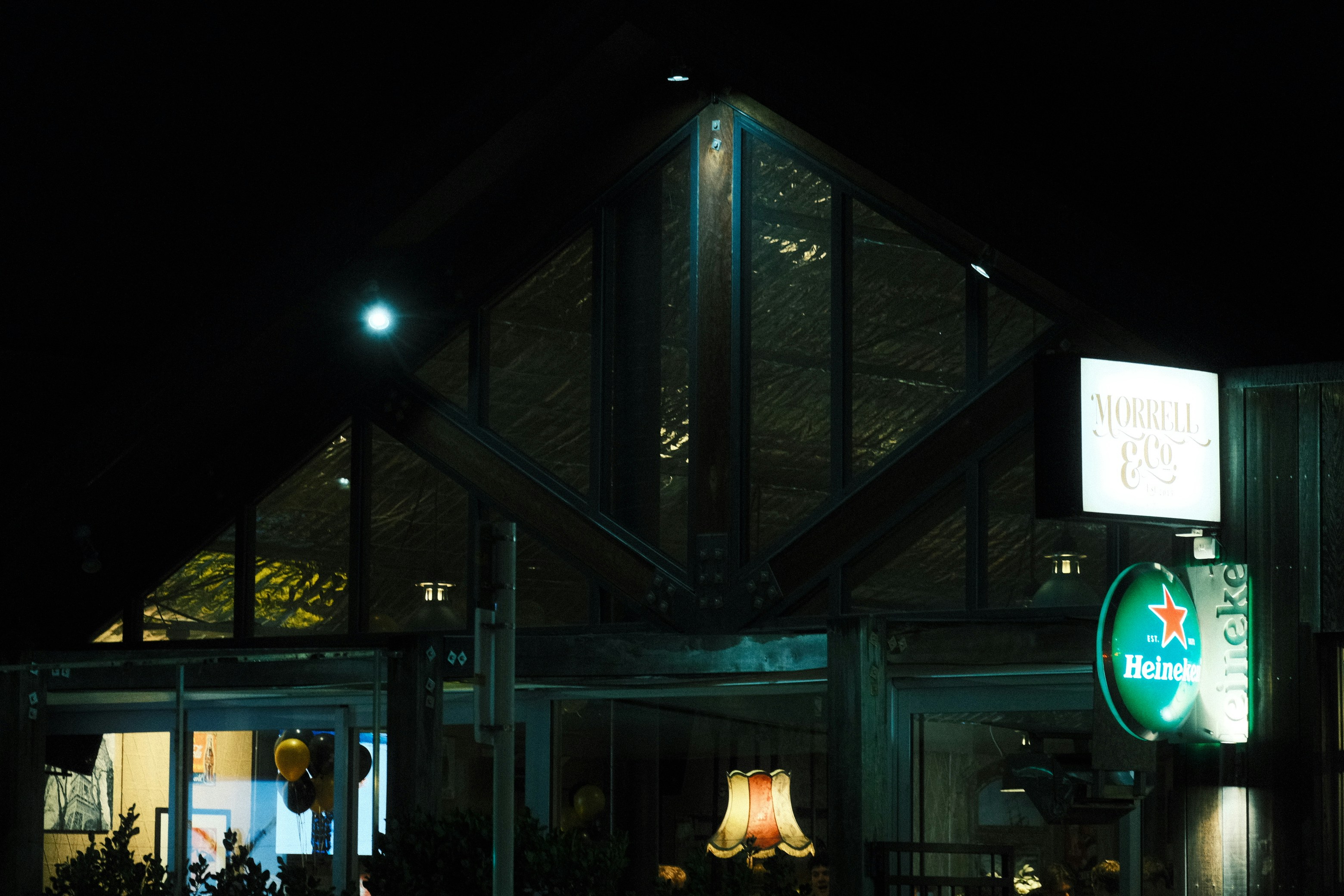 Bar exterior with glowing windows at night