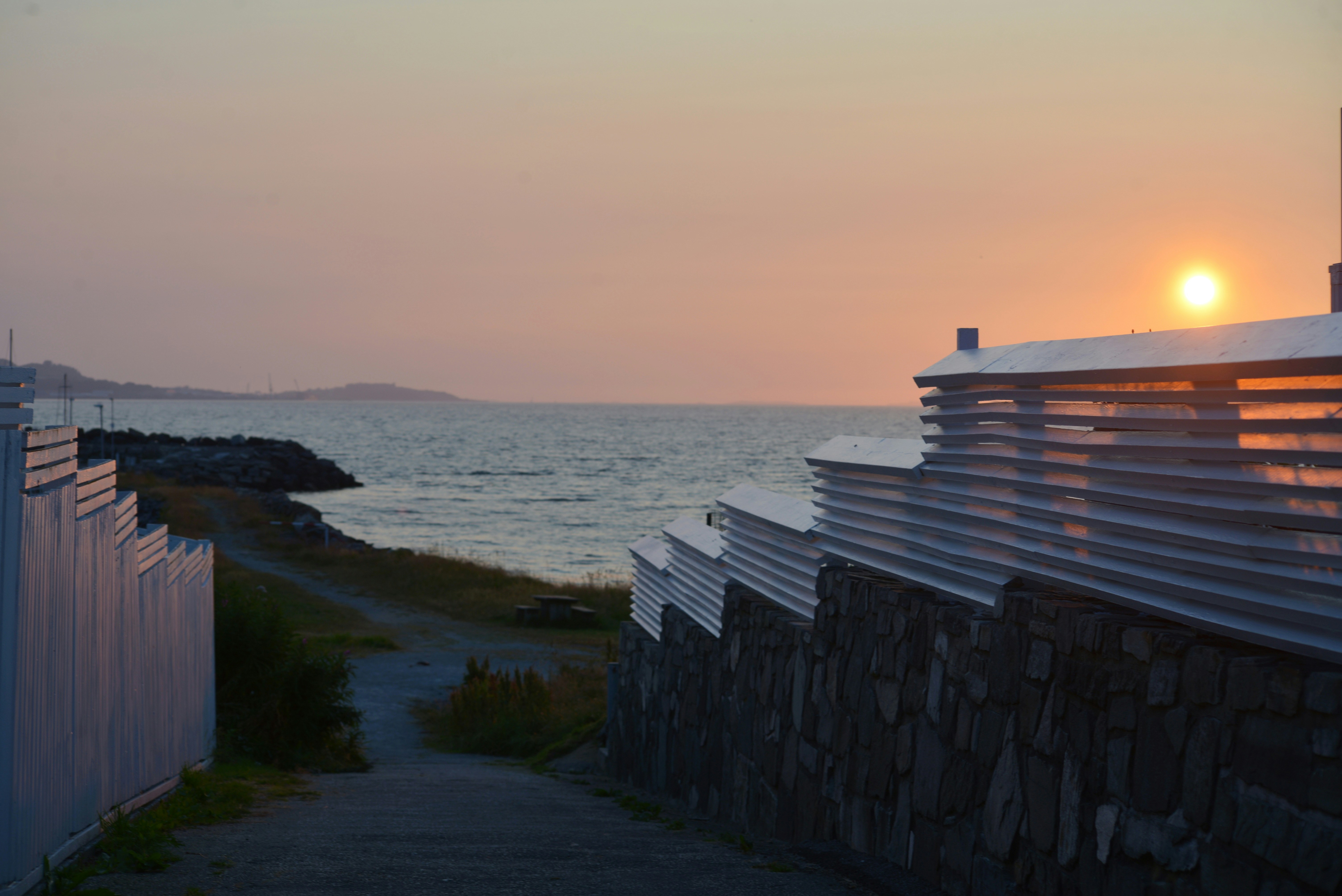 Sunset over the ocean with a path between two walls - Free Photo on ...