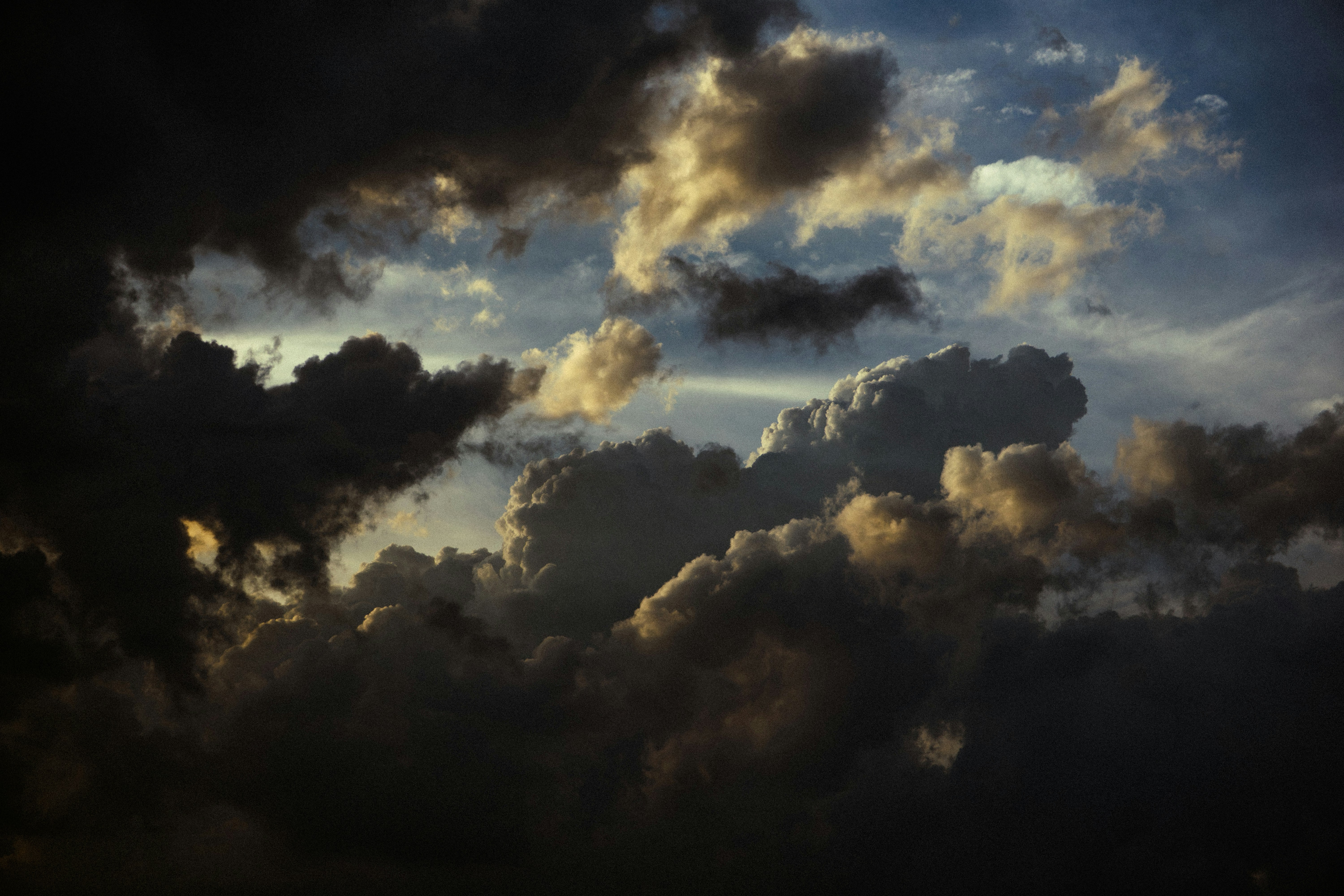 Dramatic dark clouds with light breaking through the sky.