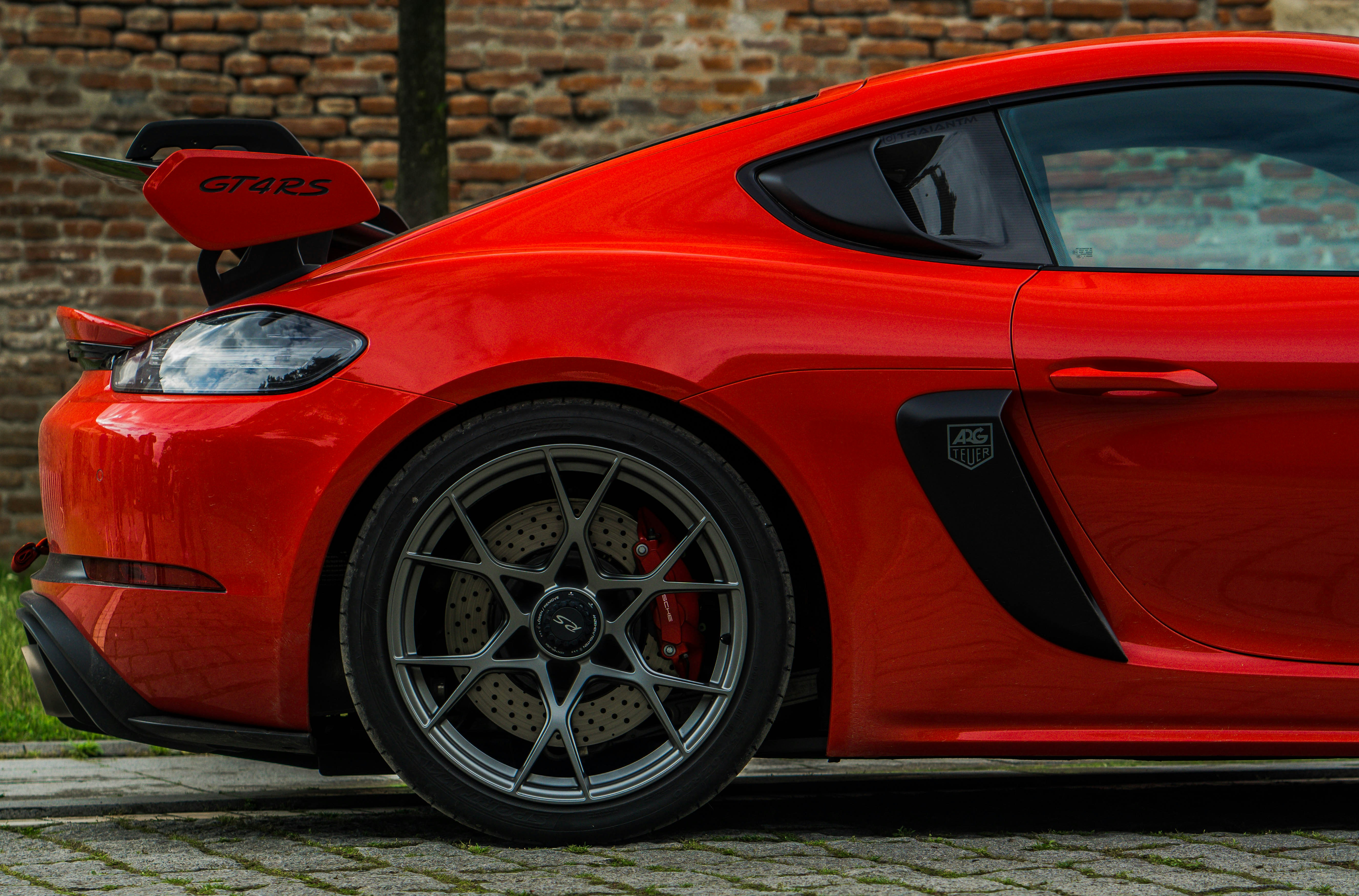 Red sports car's rear wheel and spoiler