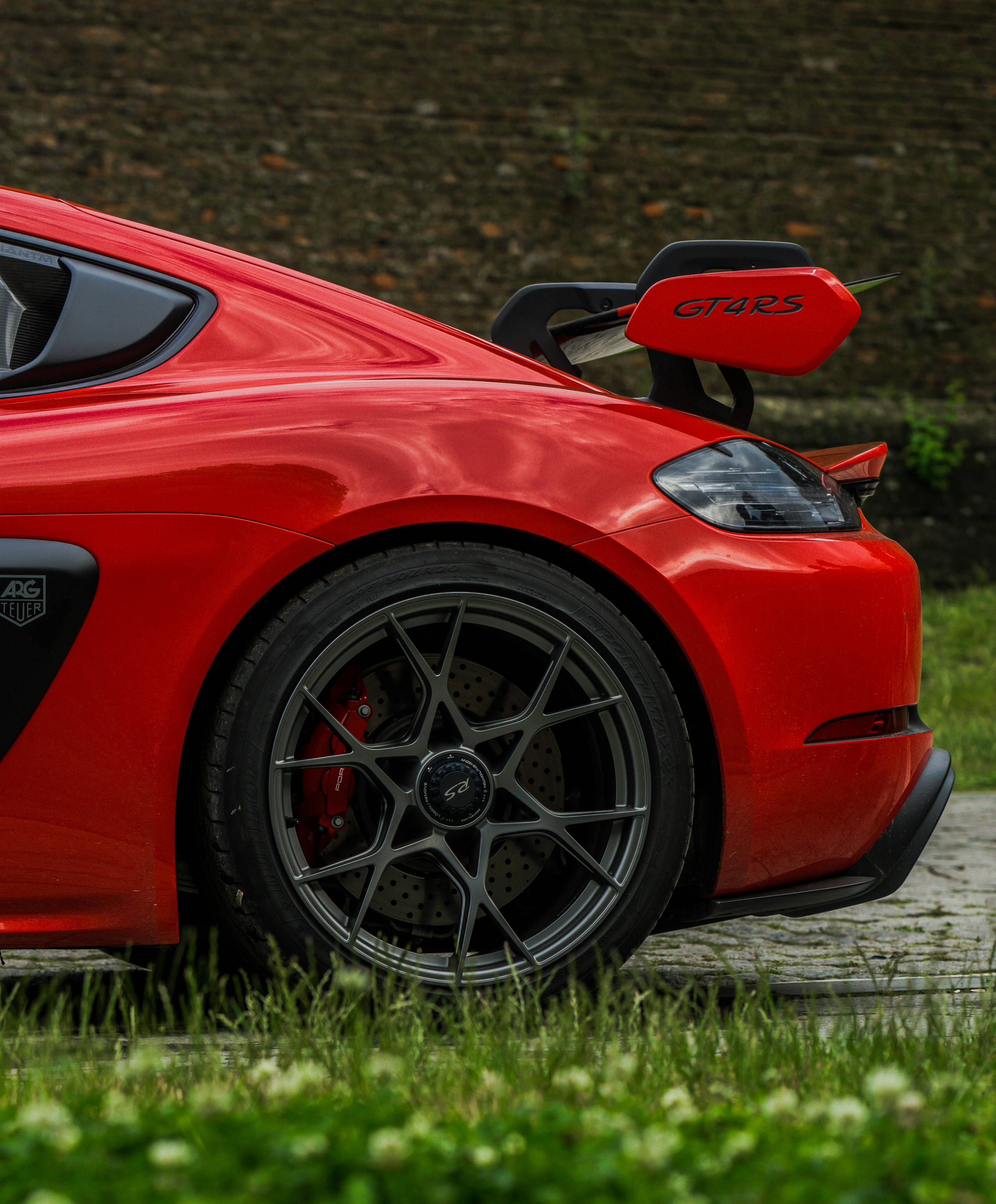 Dynamic red sports car rear with prominent spoiler