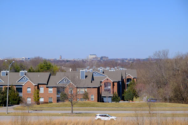 Neighborhood homes with the Kansas City skyline in the distance