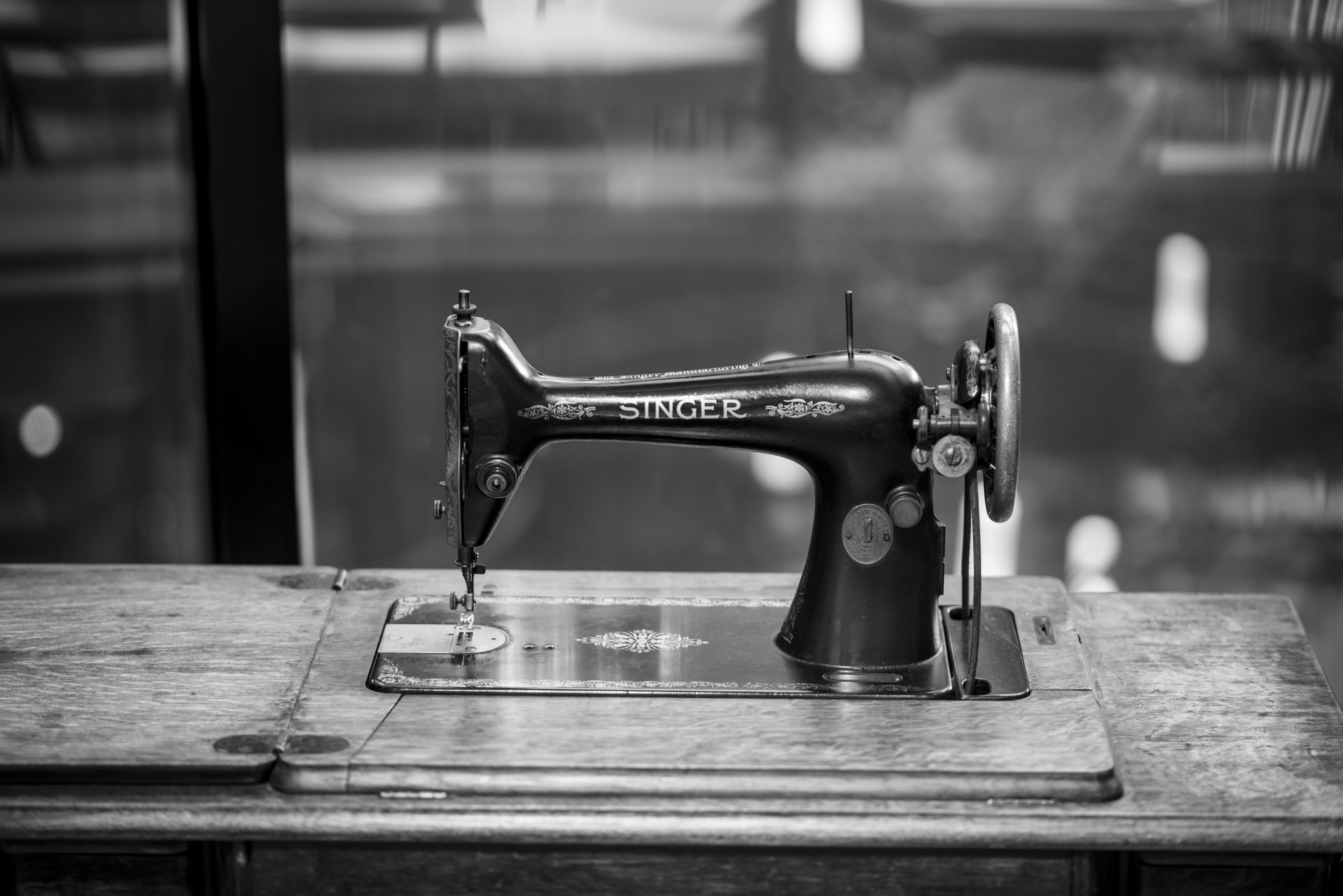 An antique singer sewing machine on a wooden table
