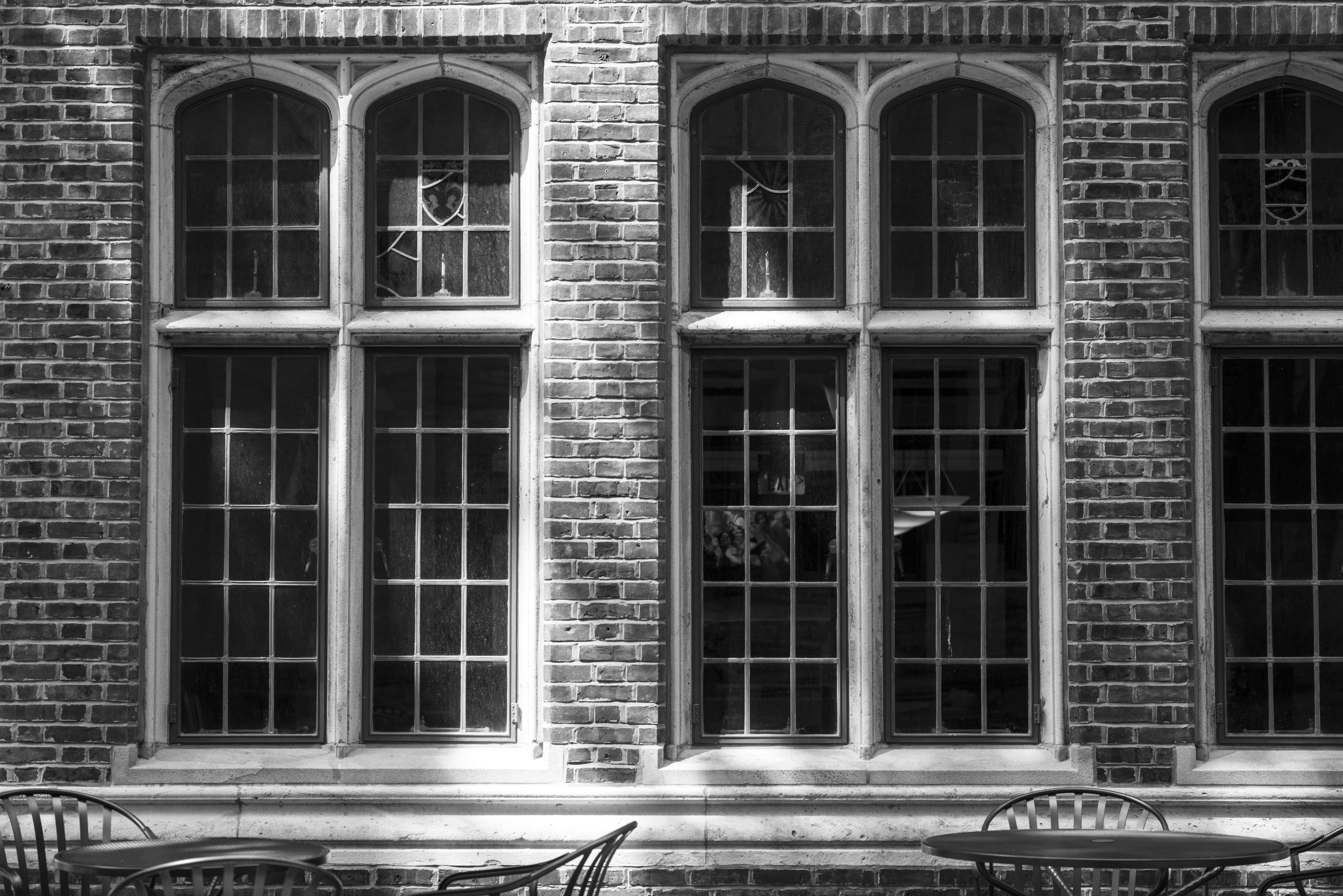 Arched windows on a brick building with outdoor seating