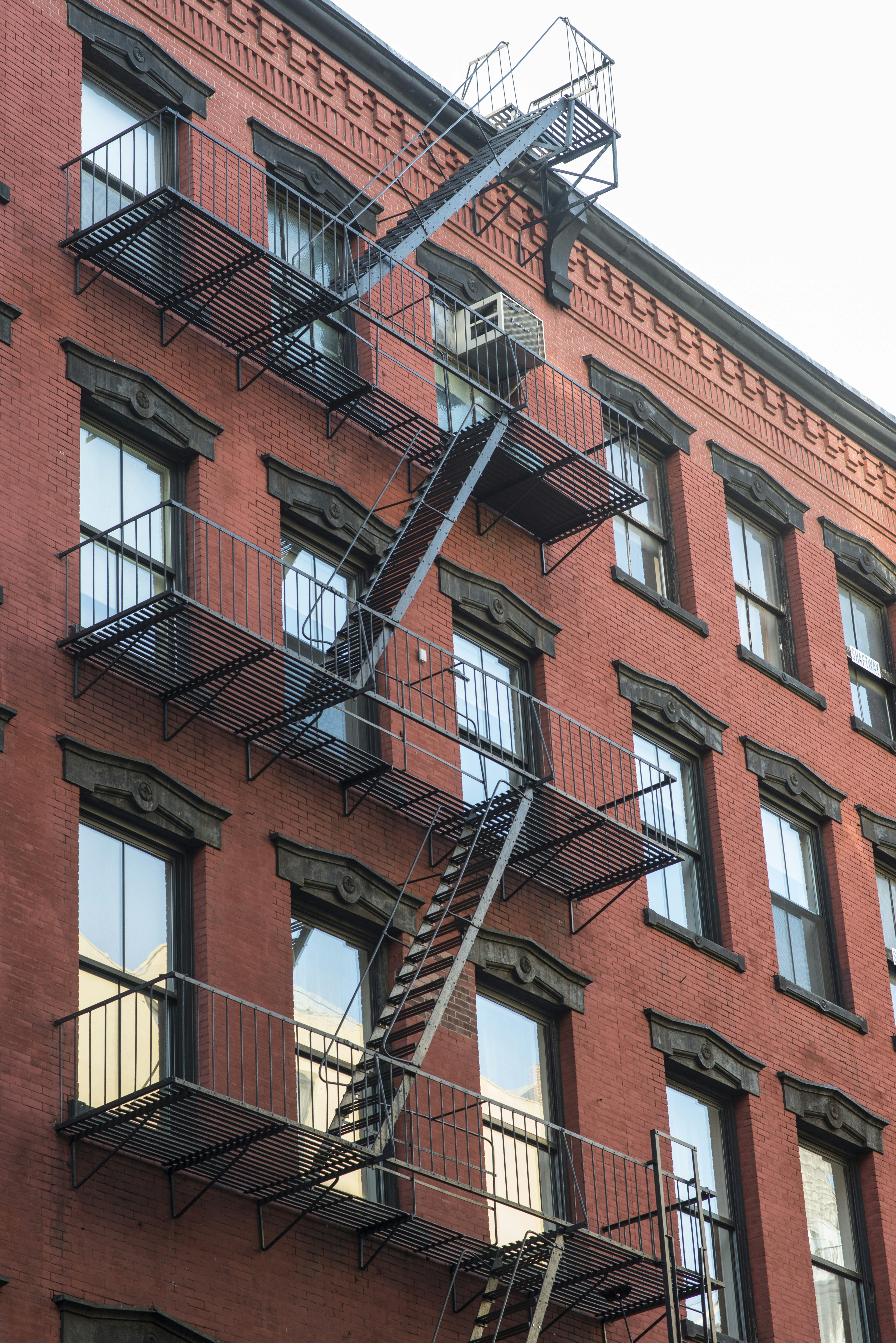 A red brick building with a black fire escape