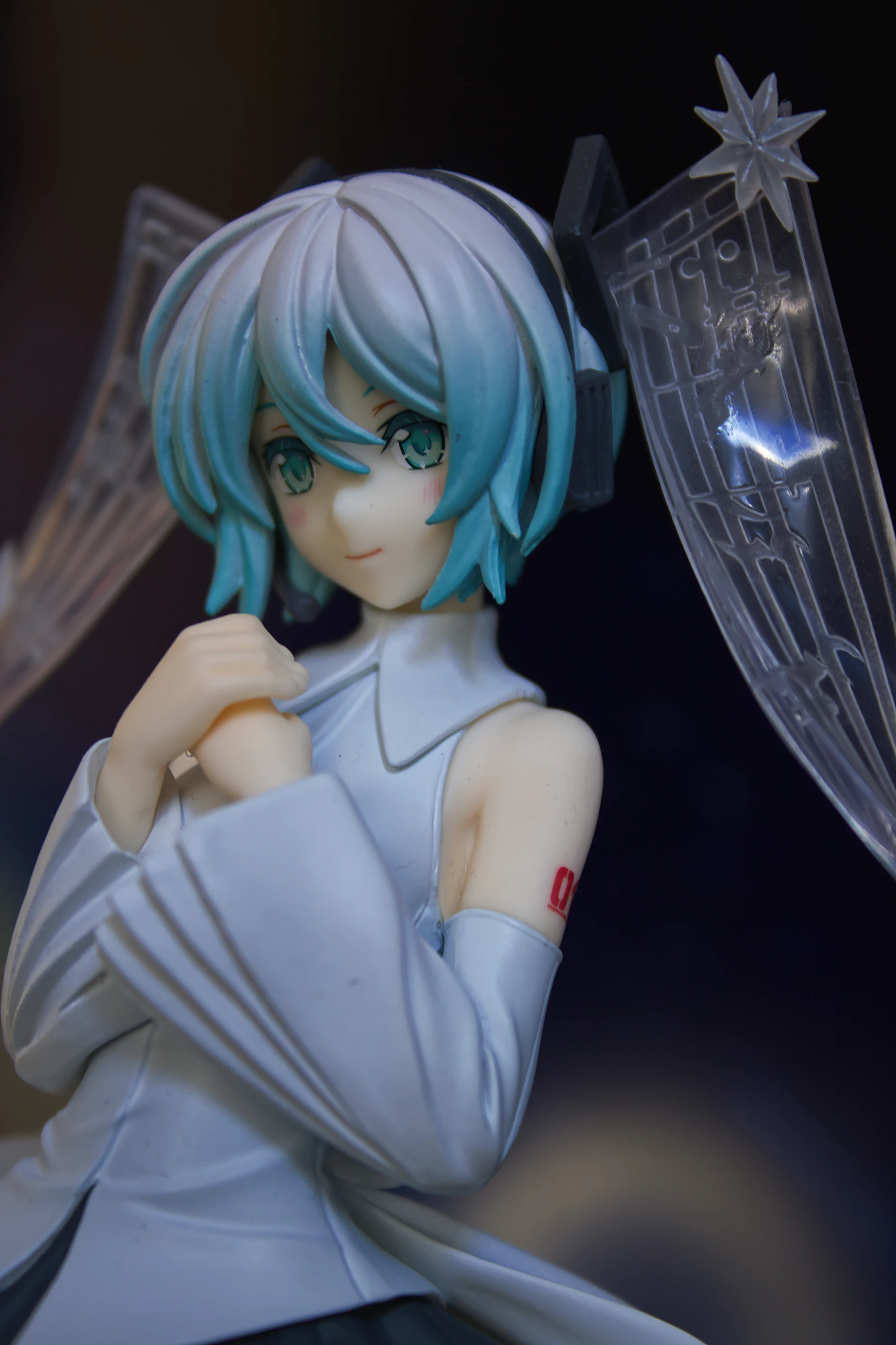 Anime figure with light blue hair and white outfit