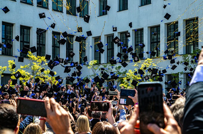 New college graduates throwing their caps into the air, many of whom will go on to rent or buy homes in Las Vegas