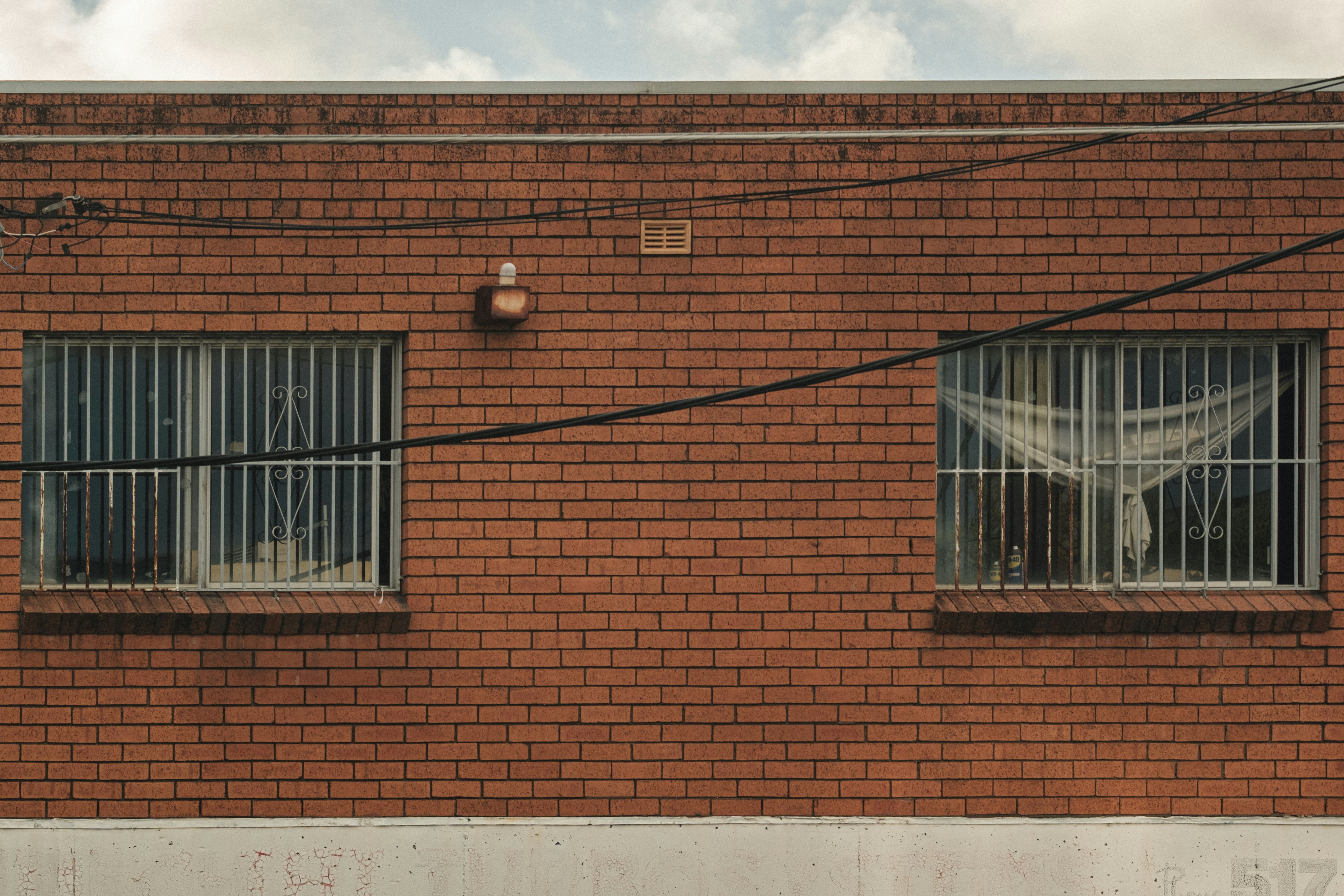 Brick building with steel security bars on the windows — window guards & security bars, Brooklyn NY