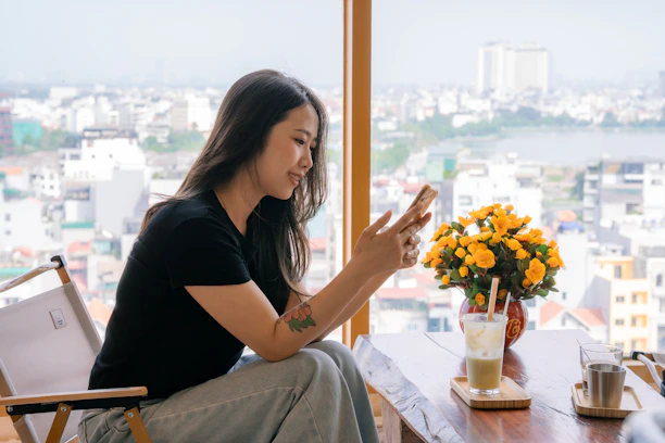 Woman using her phone while planning a trip.