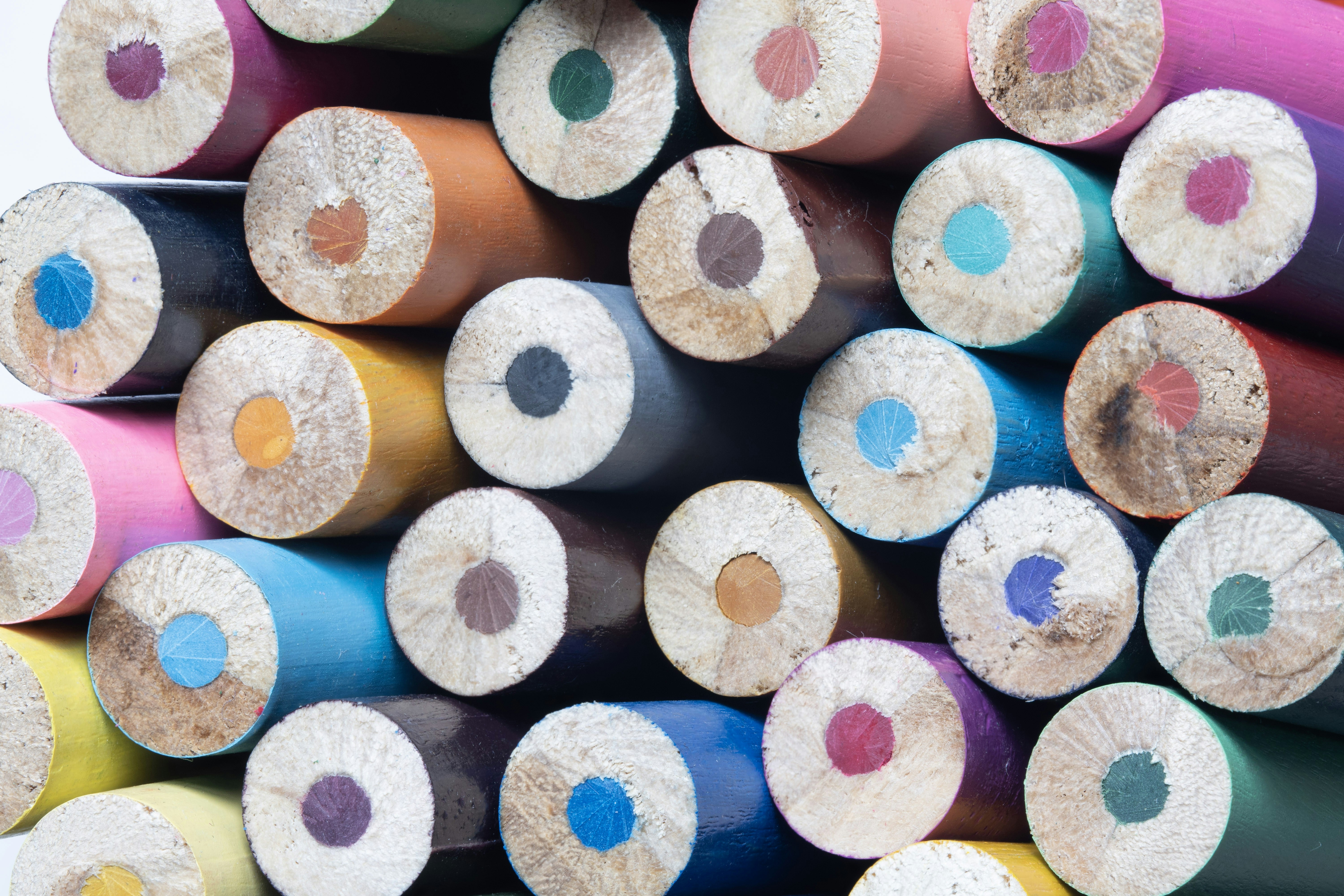 Stacked colorful pencil ends showing various colors