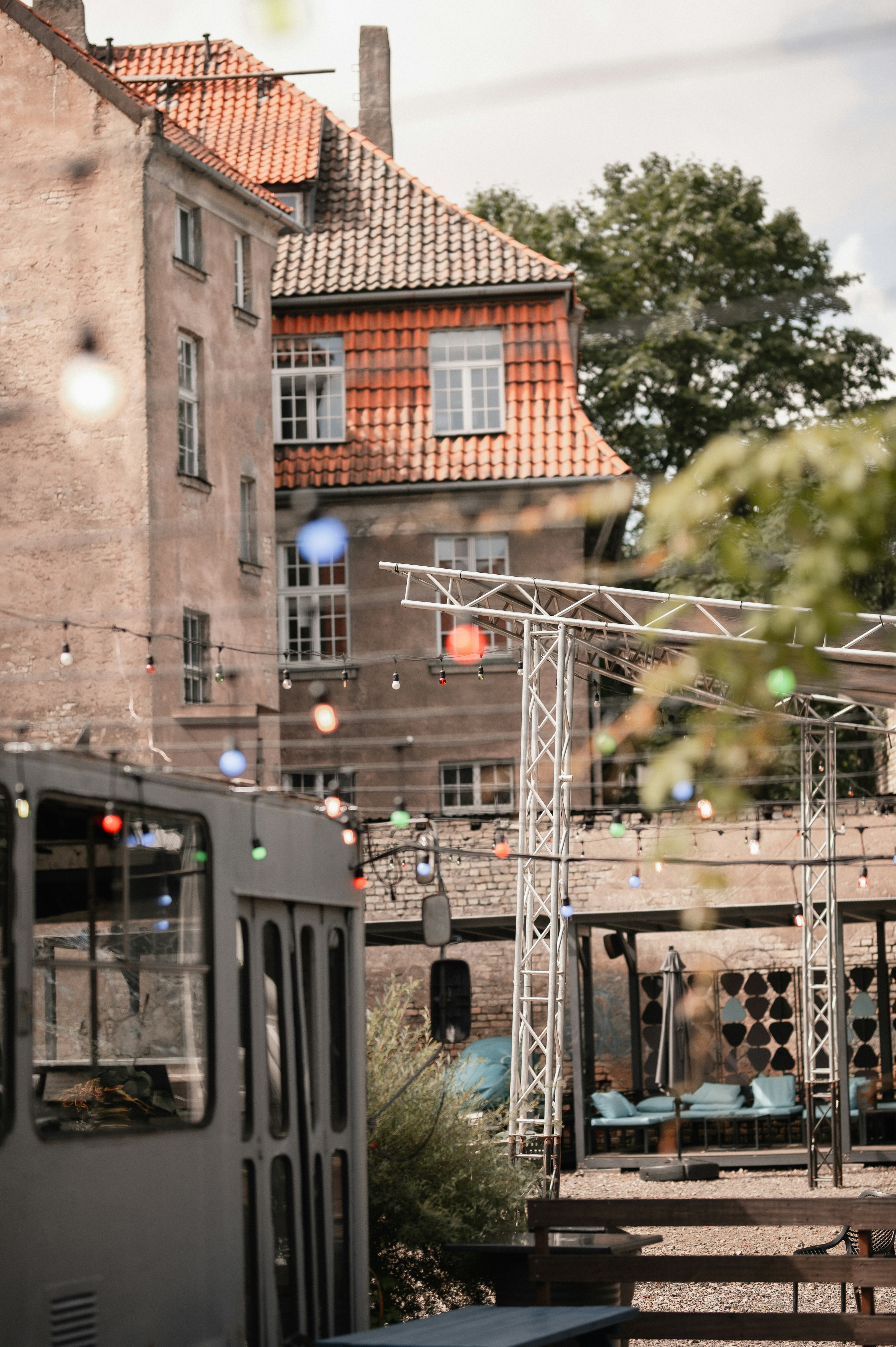 Old buildings and outdoor event space with string lights.