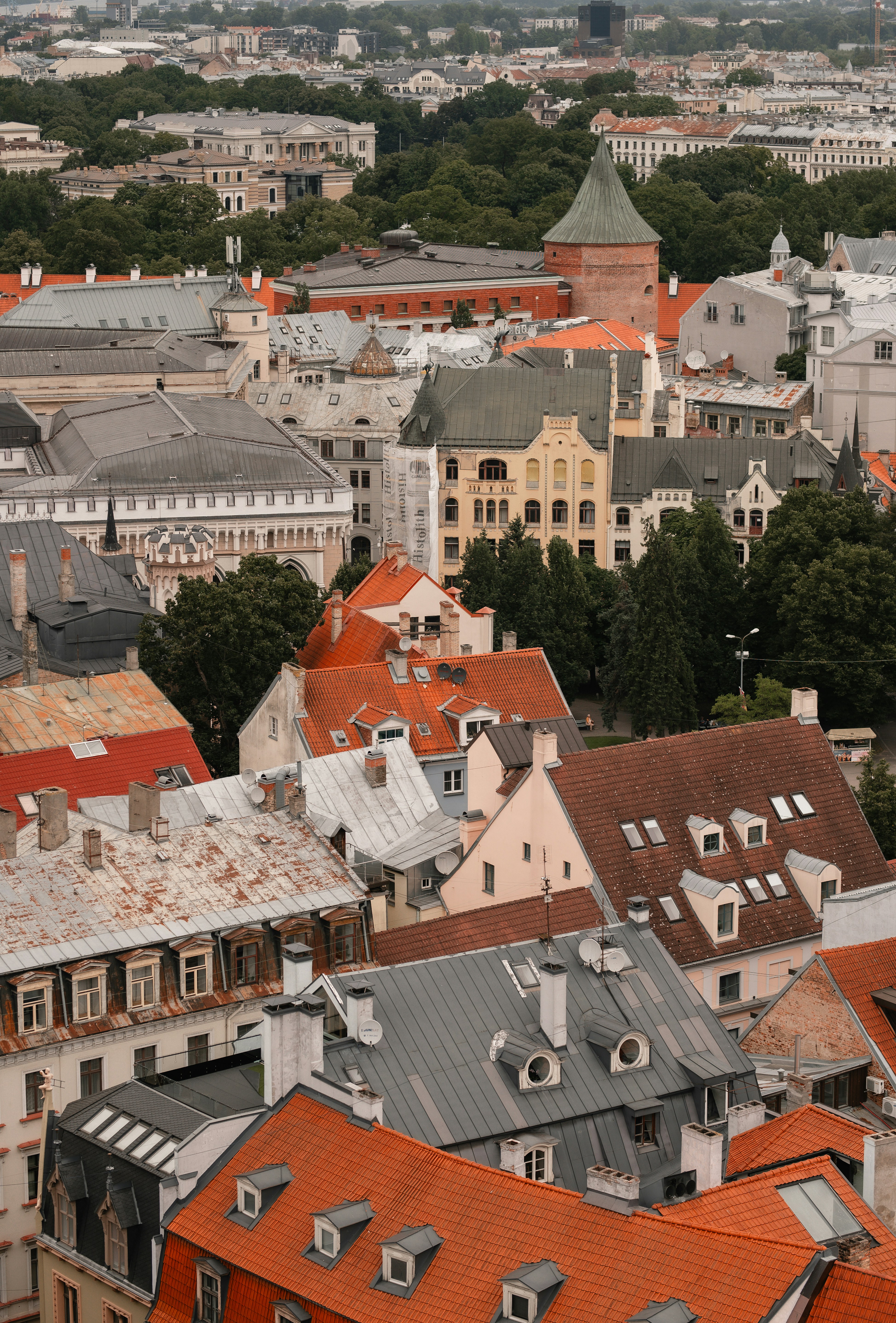 Dense cityscape with orange and grey rooftops from above.