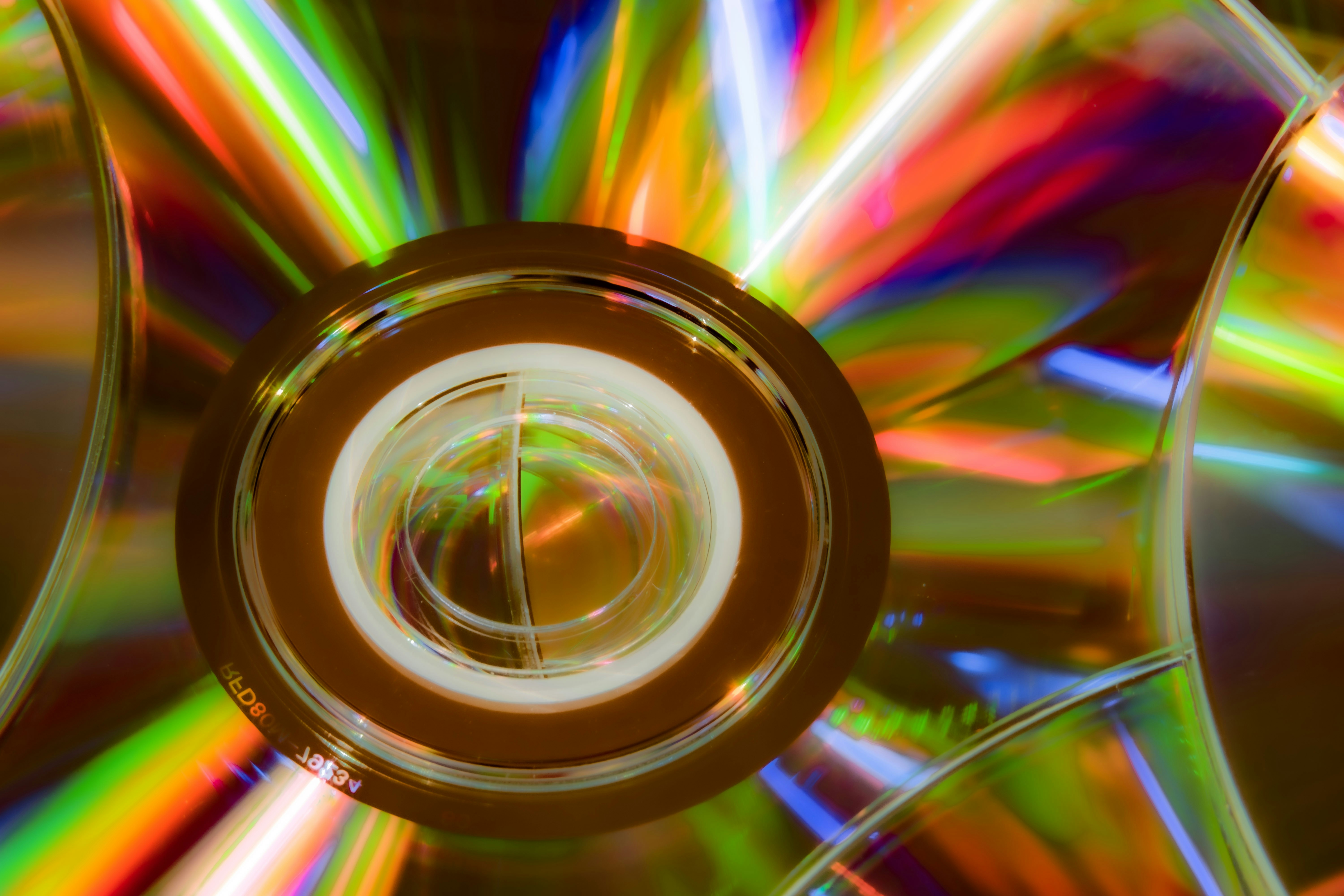 Abstract vibrant rainbow reflections on multiple compact discs