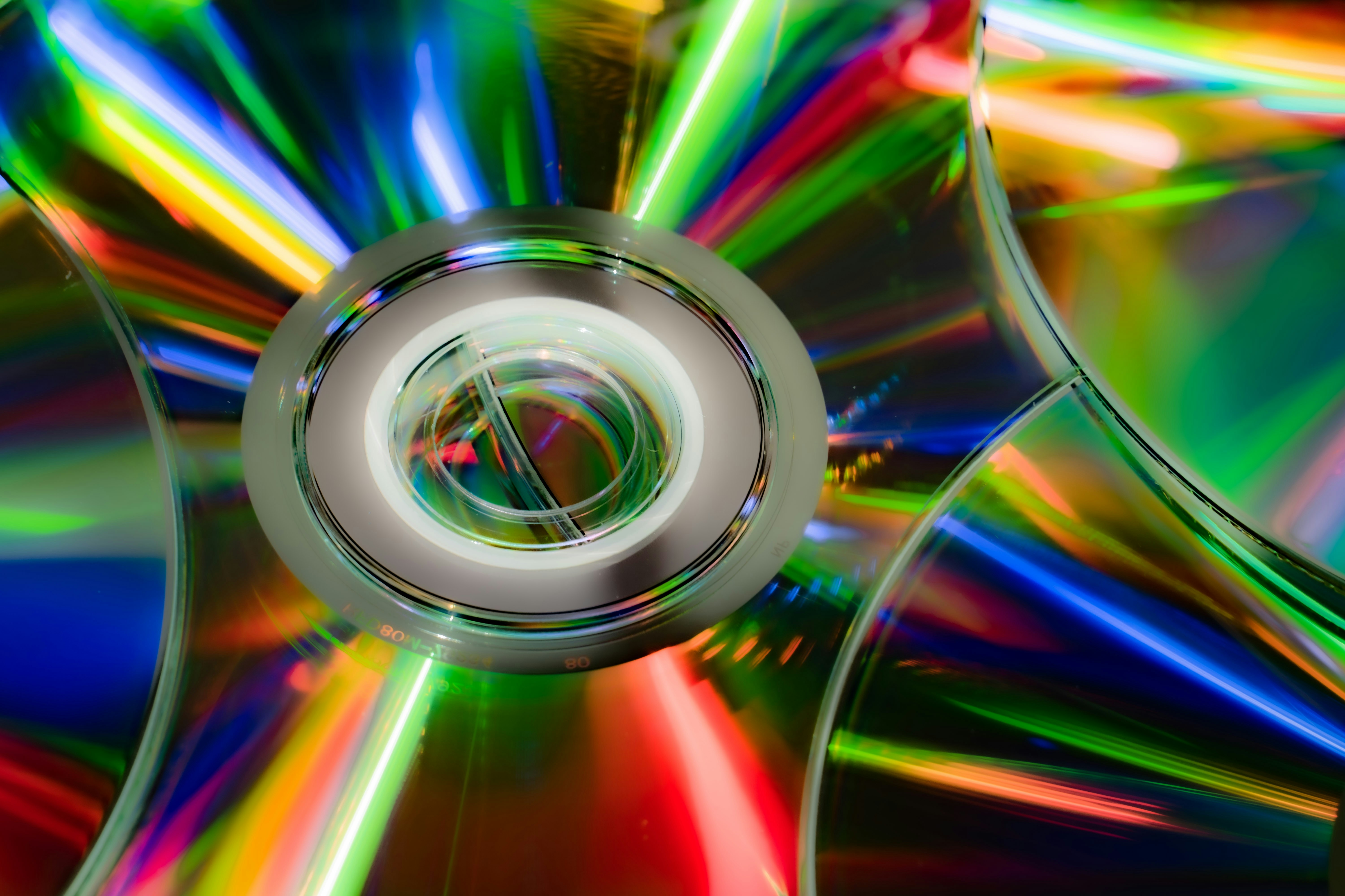 Cds reflecting vibrant, colorful light patterns.