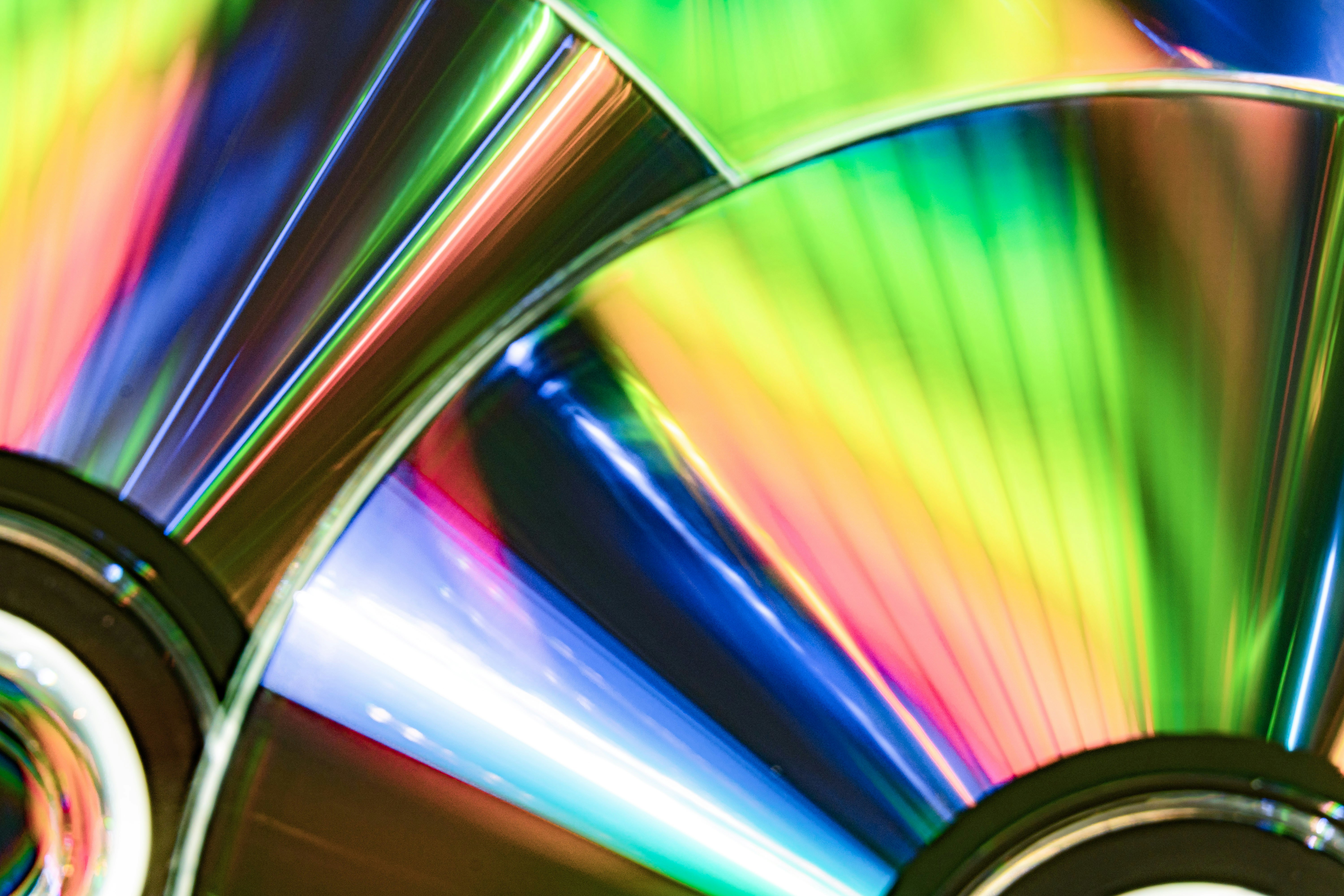 Cds reflecting vibrant rainbow colors.