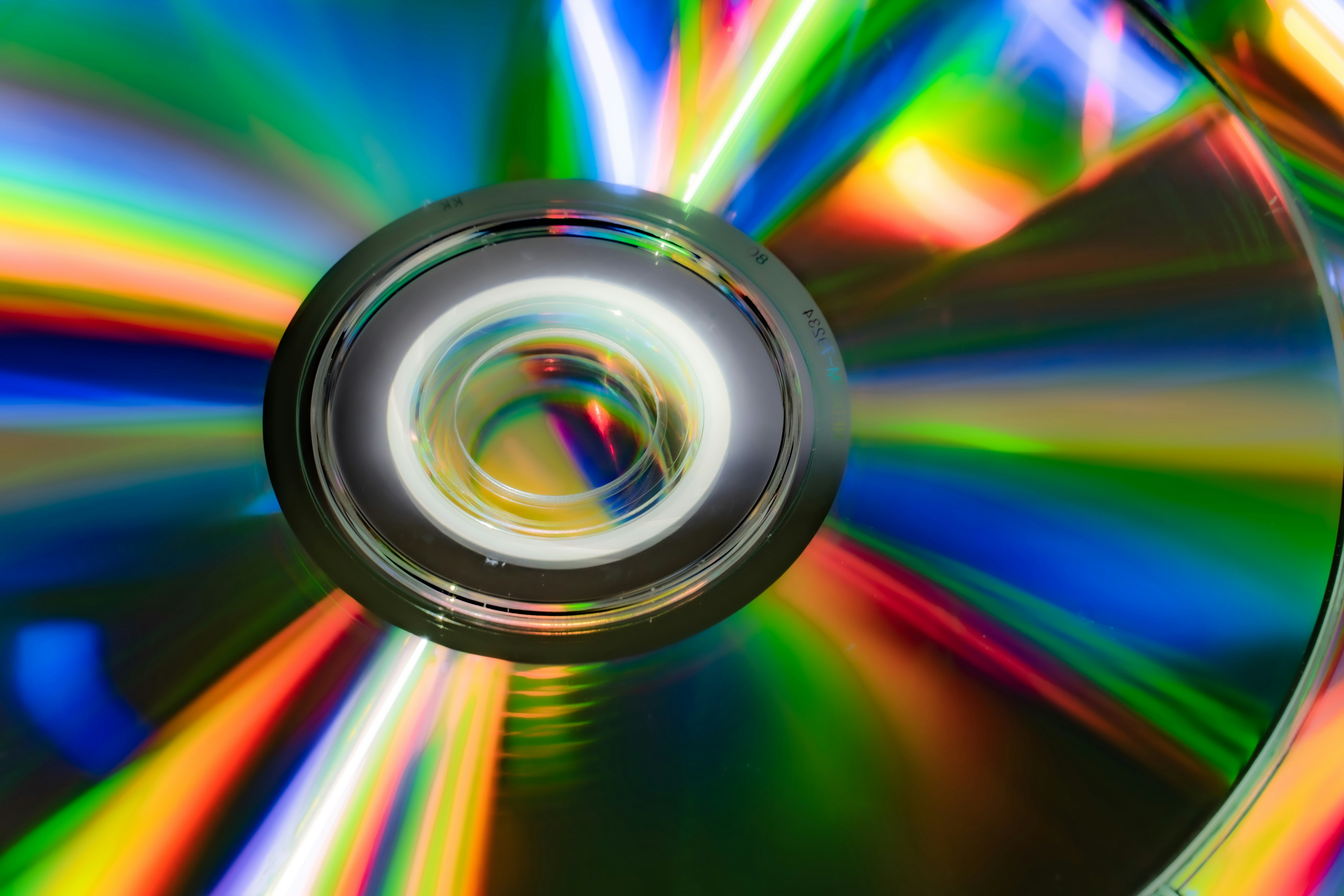 A cd with colorful light reflections and abstract patterns.