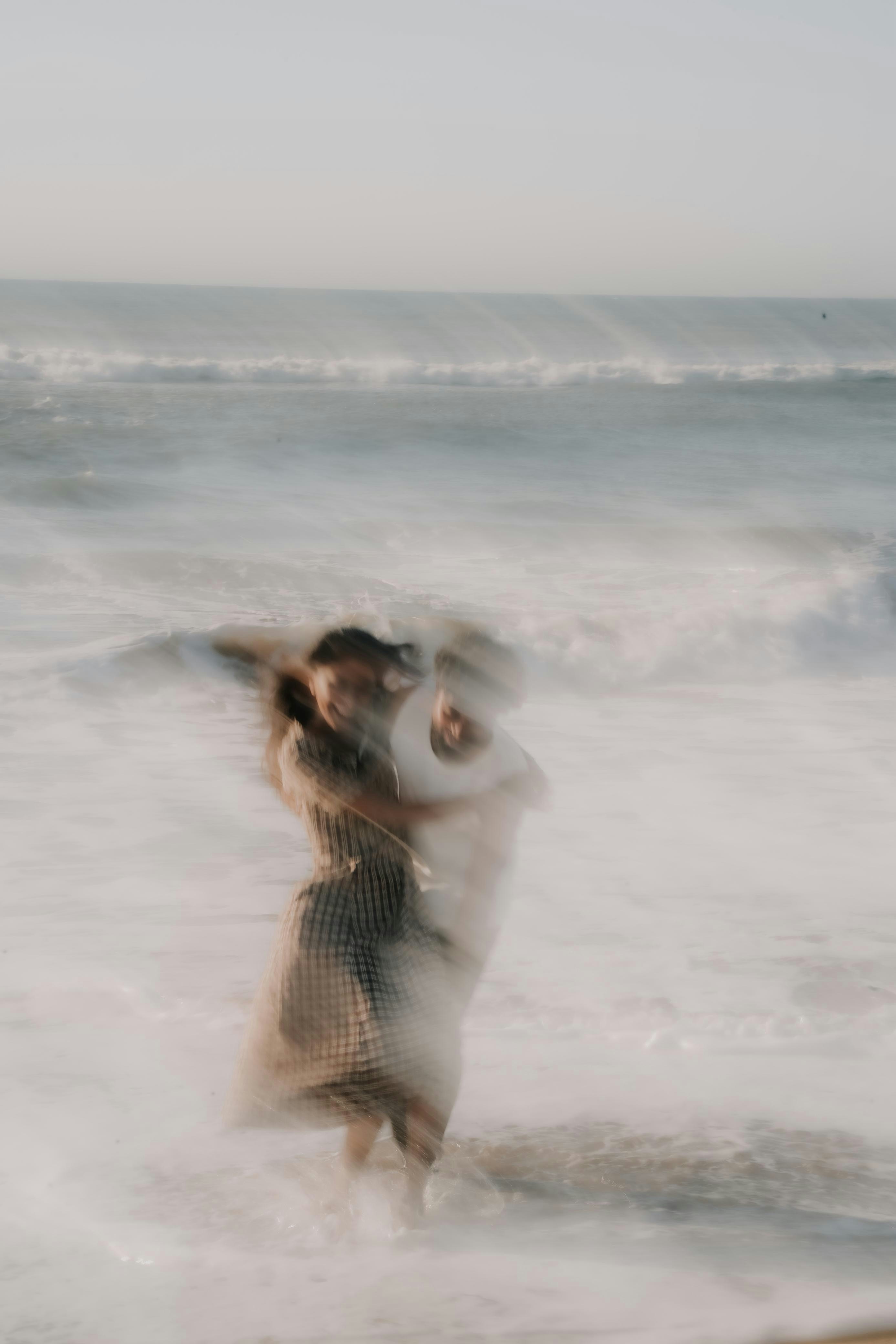 Blurred people embracing in ocean surf - Free Photo on Unsplash