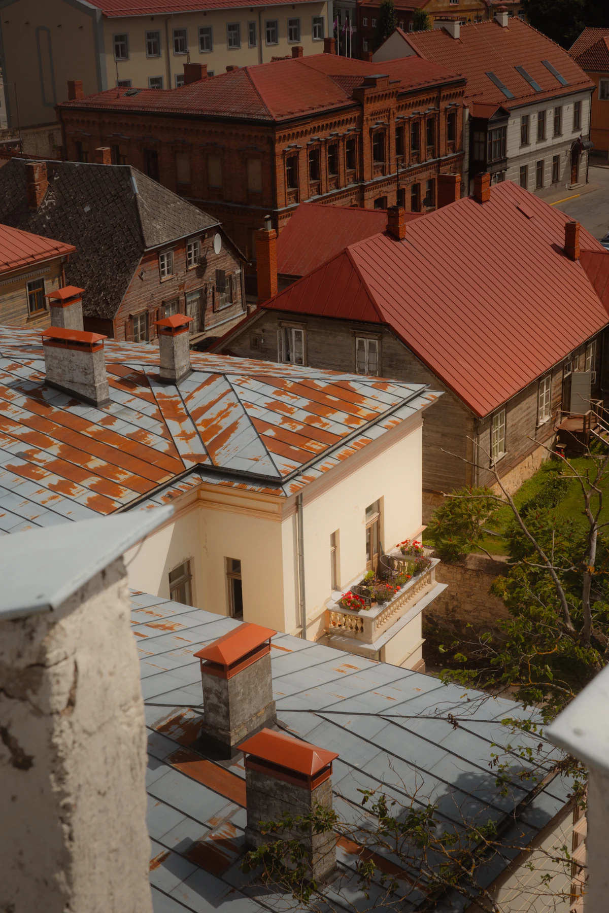 Red and rusted metal roofs in the old town of Cēsis