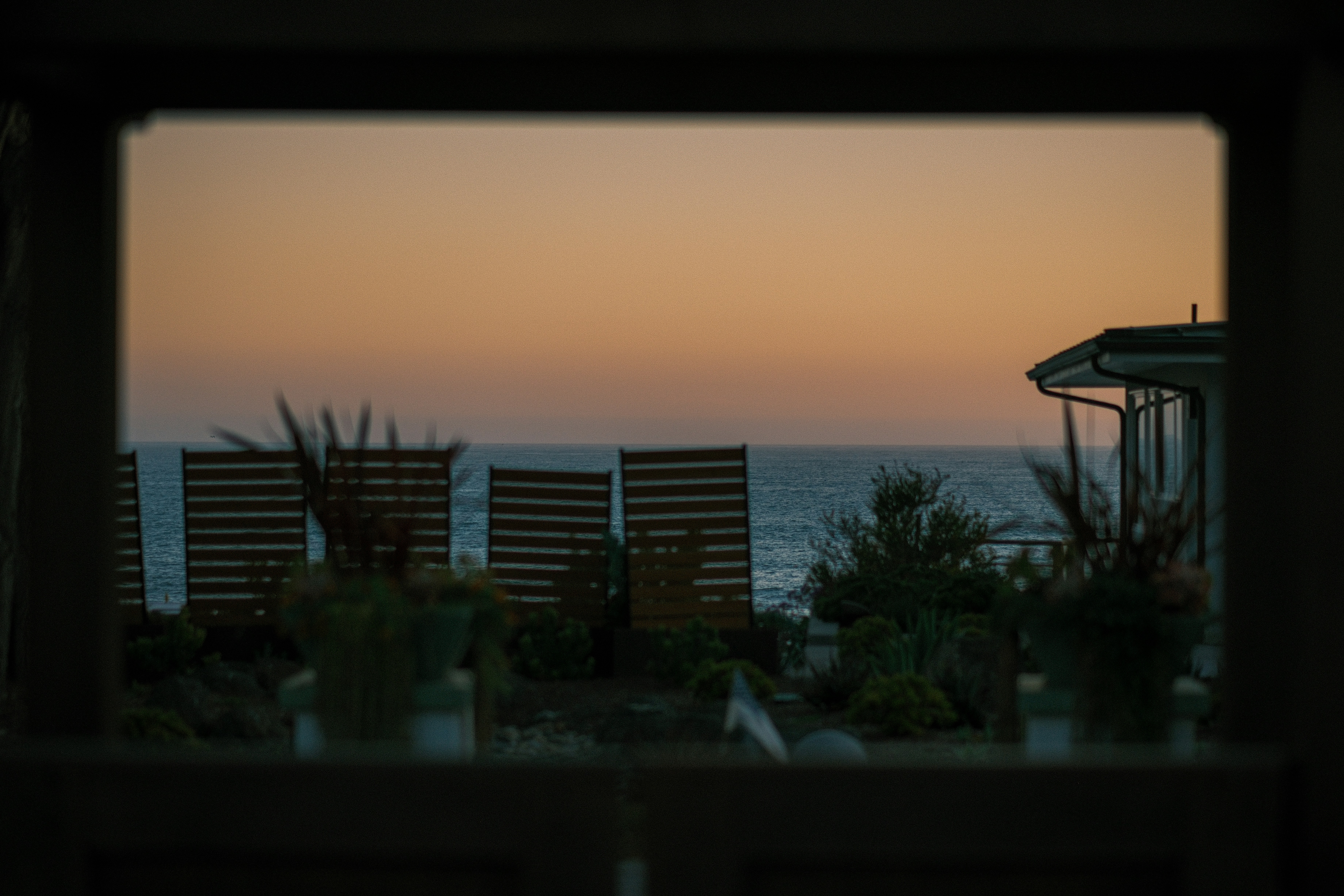 Beautiful ocean sunset seen through a dark border.