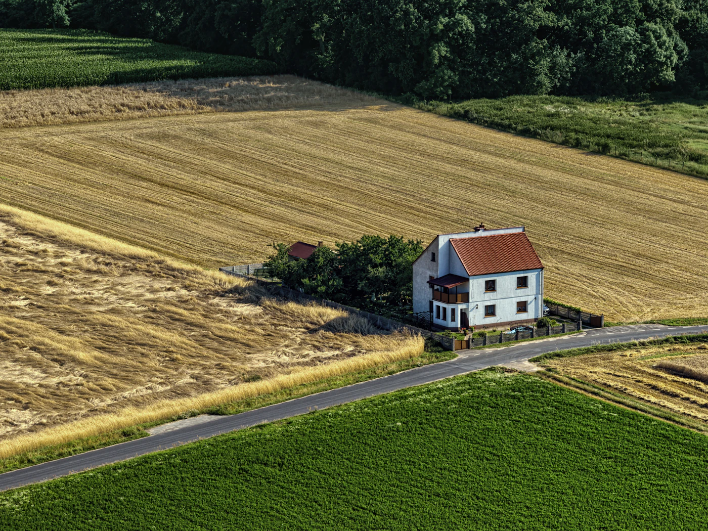 Small house surrounded by farm fields
