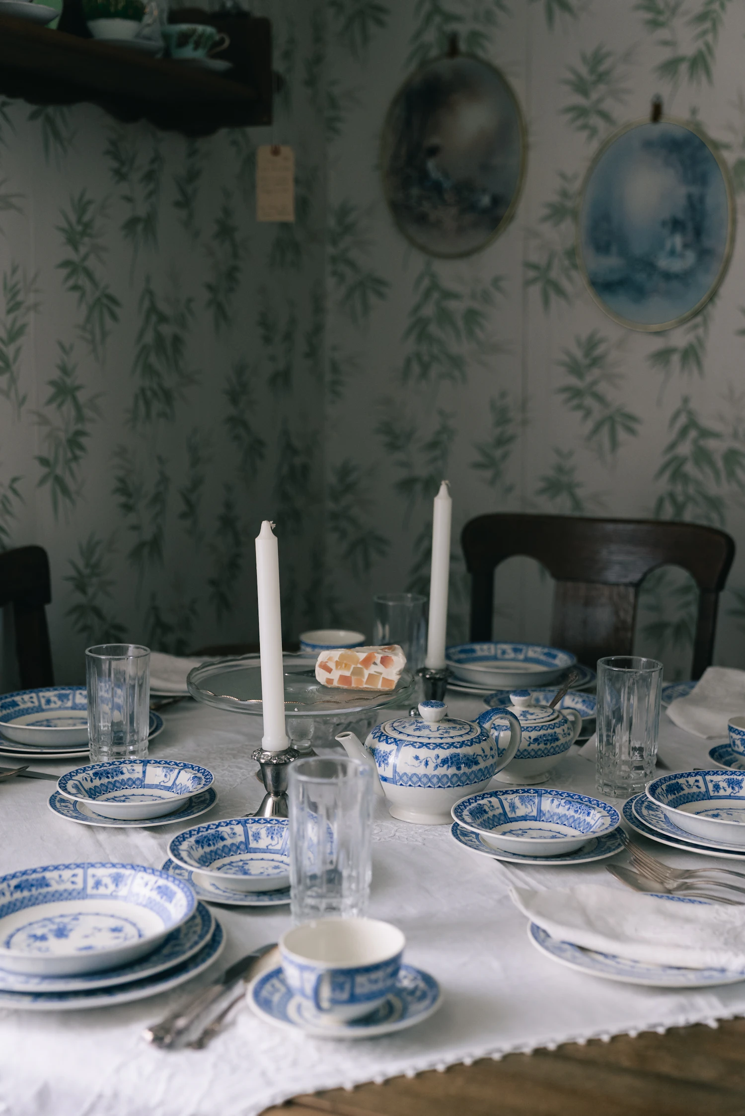 Elegant table setting with porcelain plates, teaware and glassware