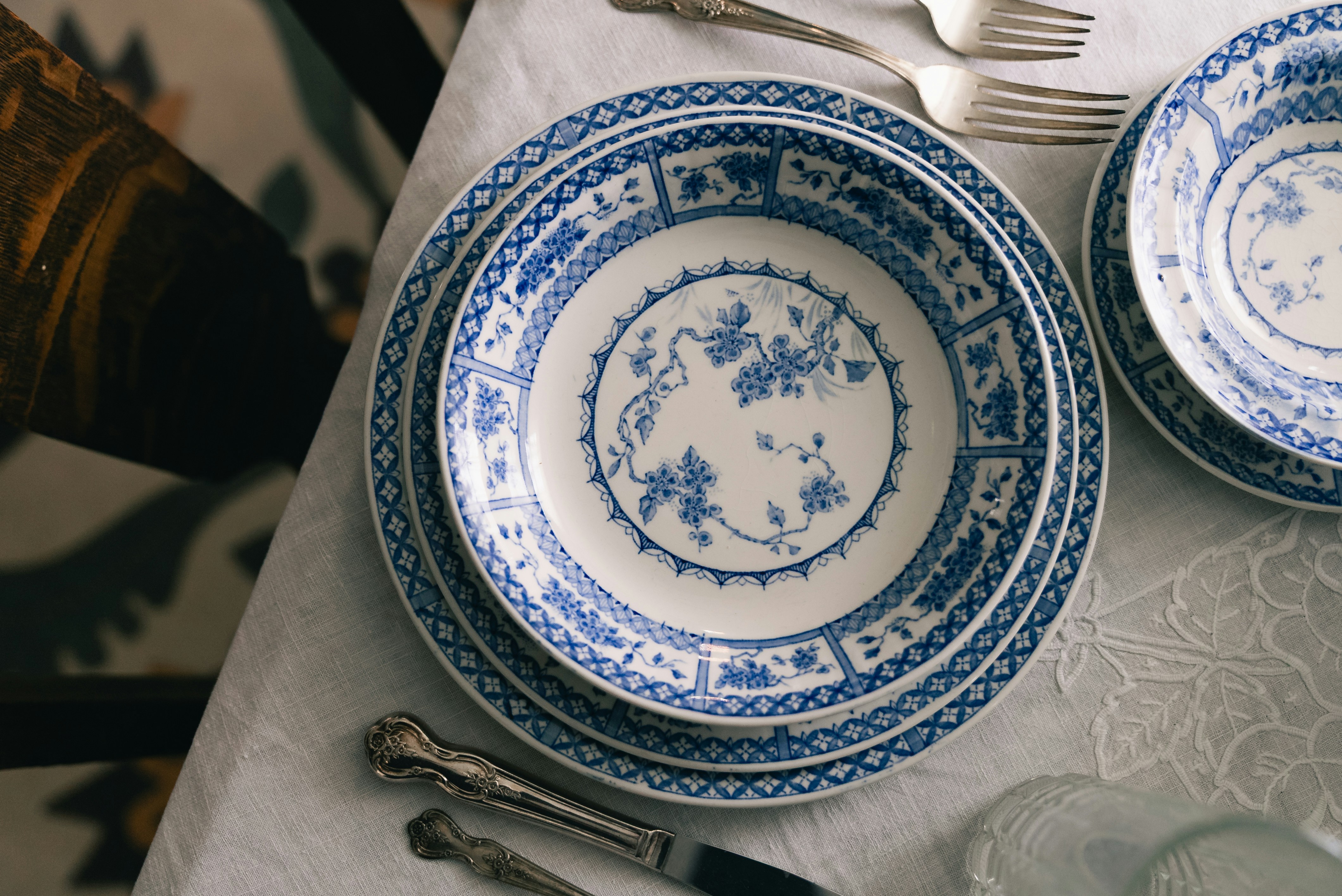 Blue and white patterned dinnerware set on a table.