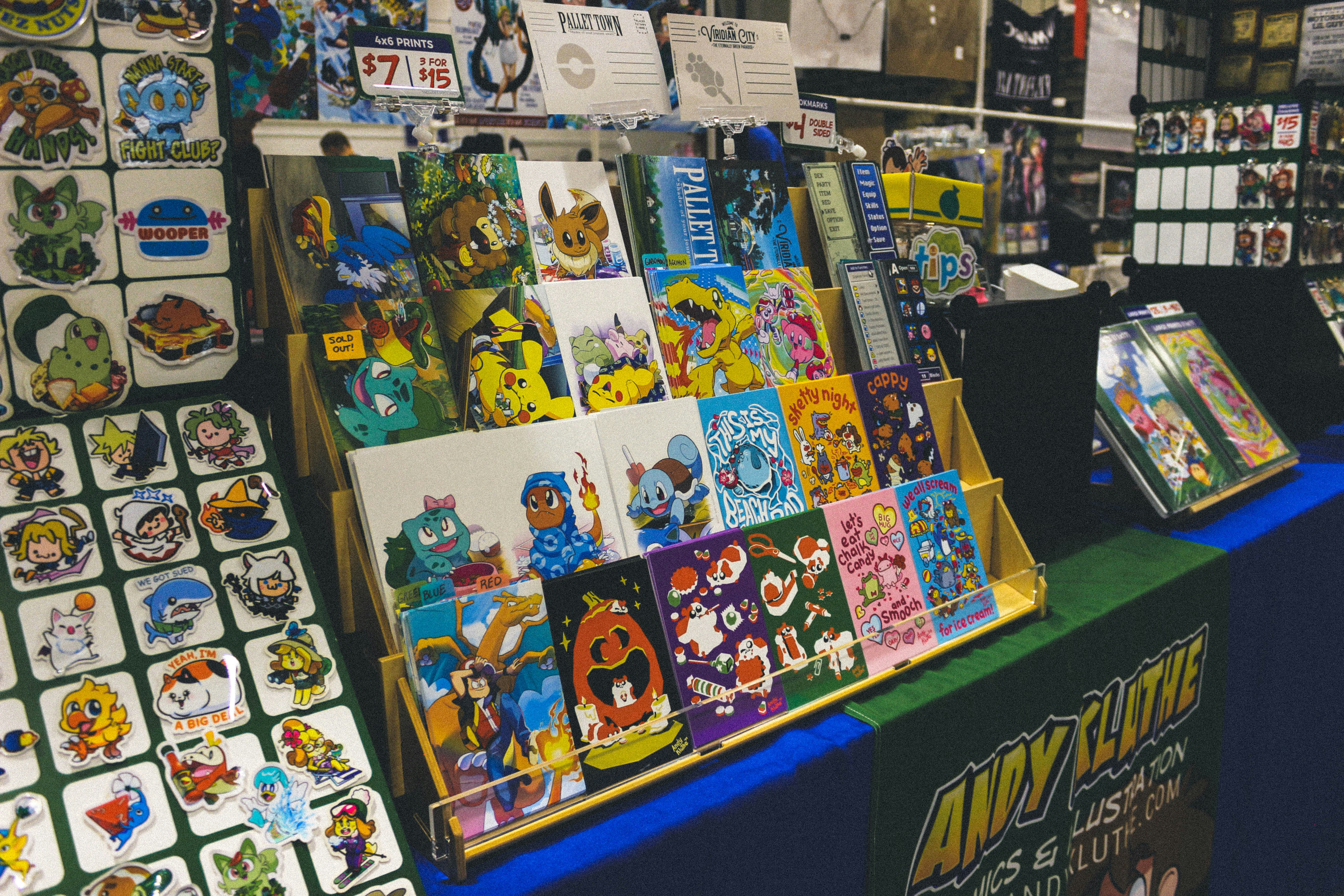 Booth with colorful cartoon art prints and character merchandise