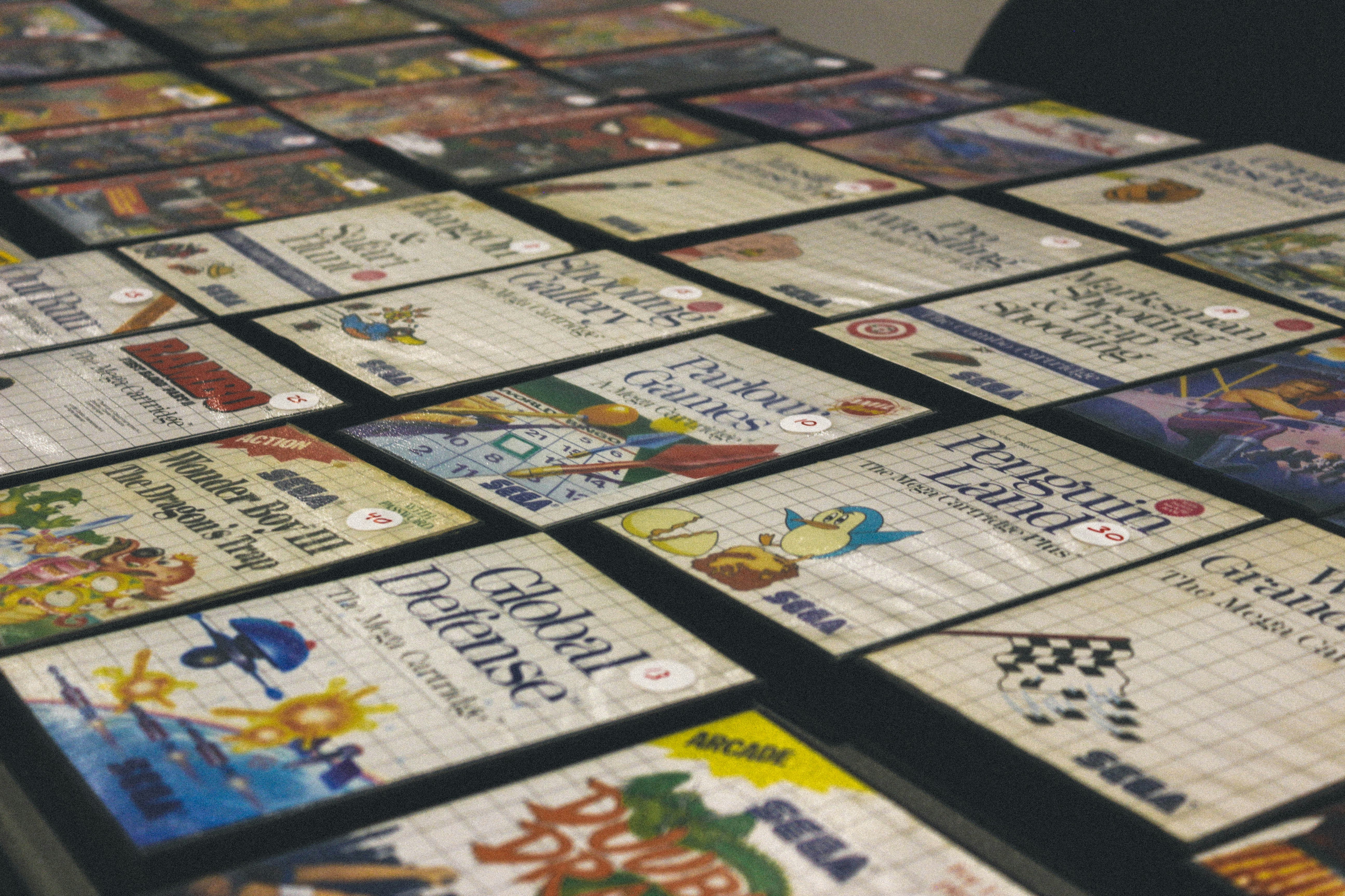 Many retro sega master system game cartridges displayed.