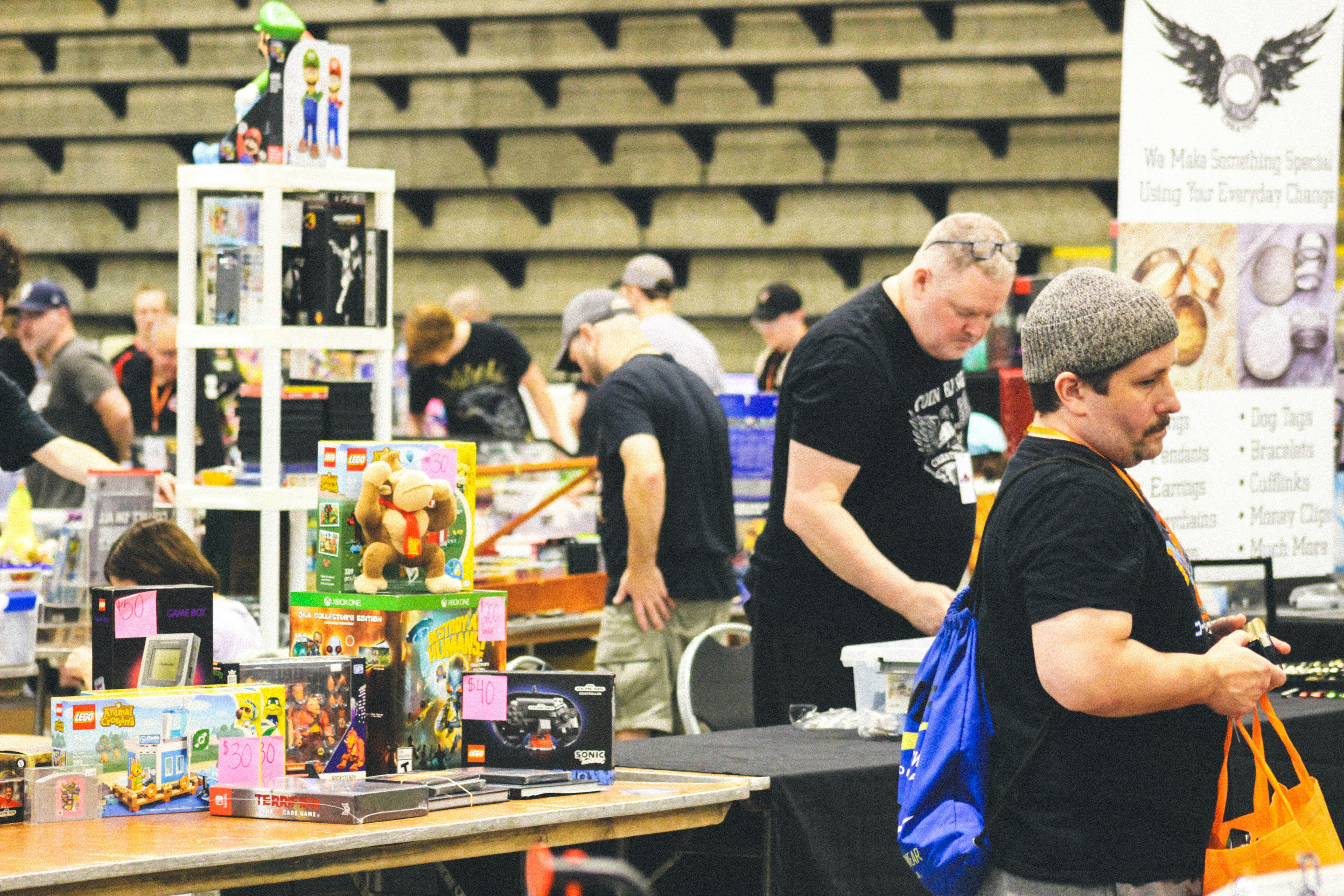 People browsing merchandise at an indoor convention or market
