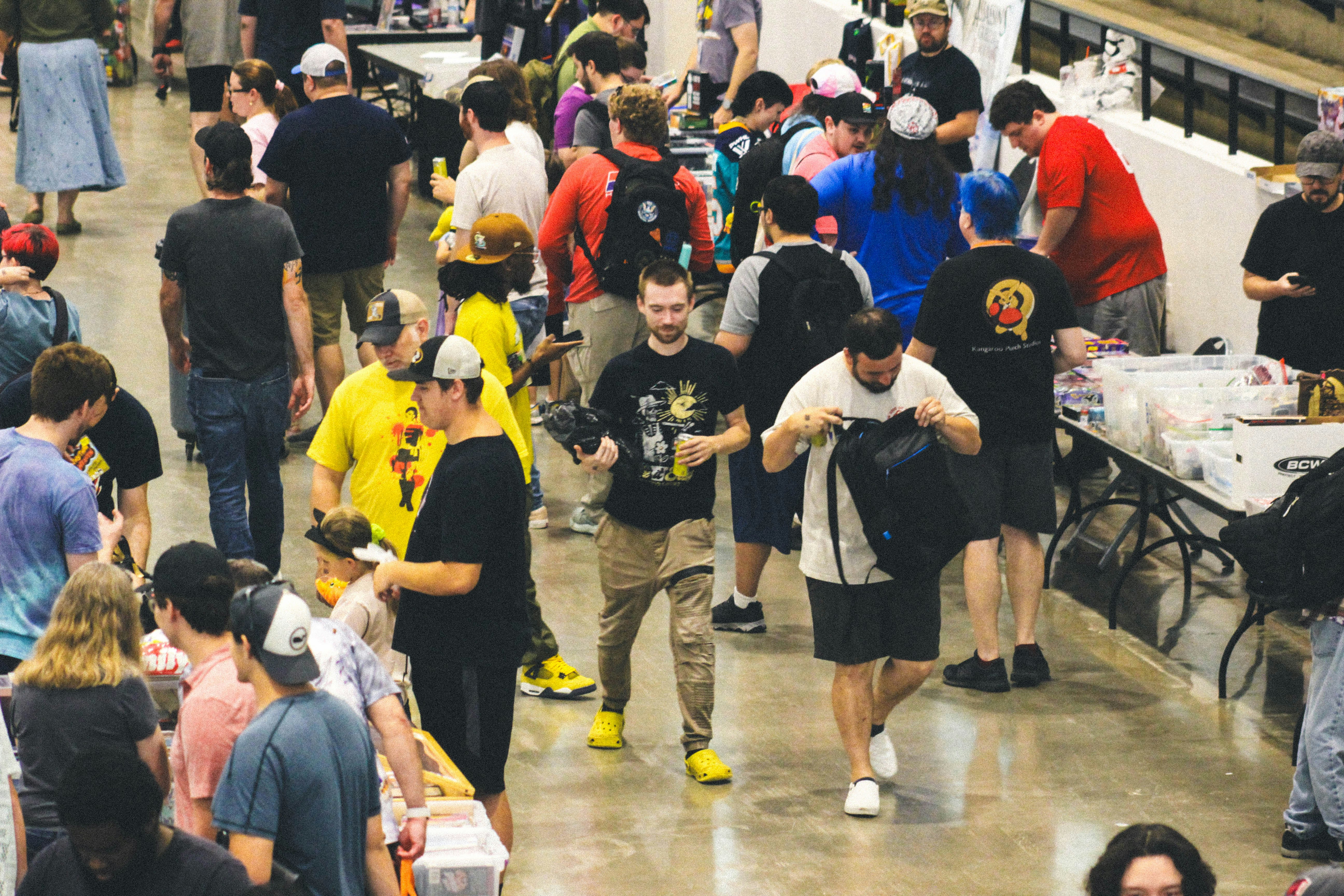 A large crowd of people walking at an indoor event