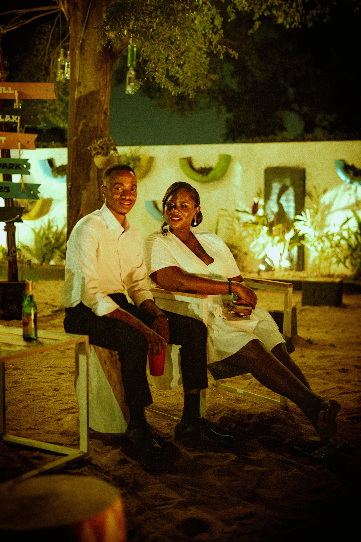 An older couple sitting together outdoors in the evening