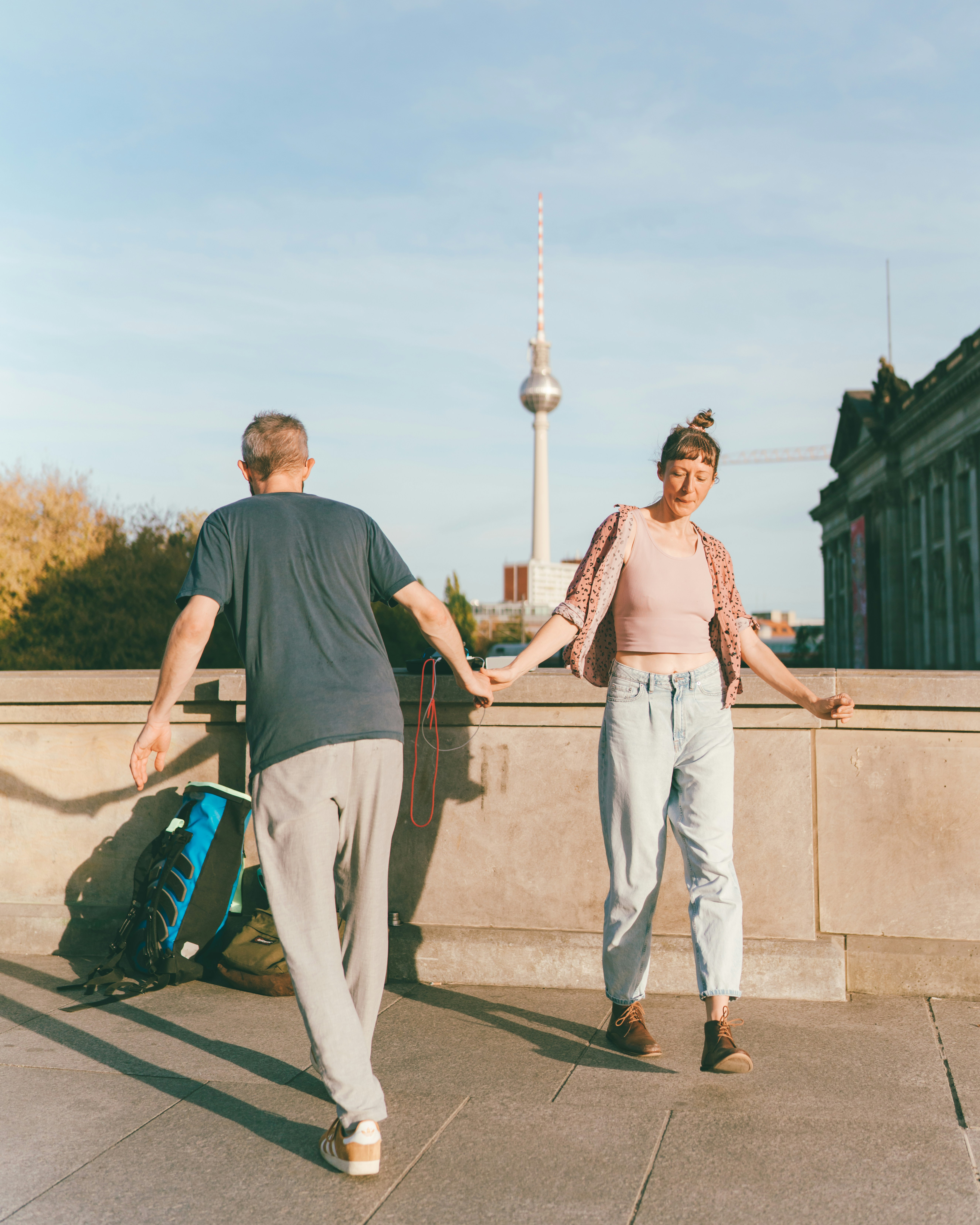 Couple holding hands in berlin with fernsehturm