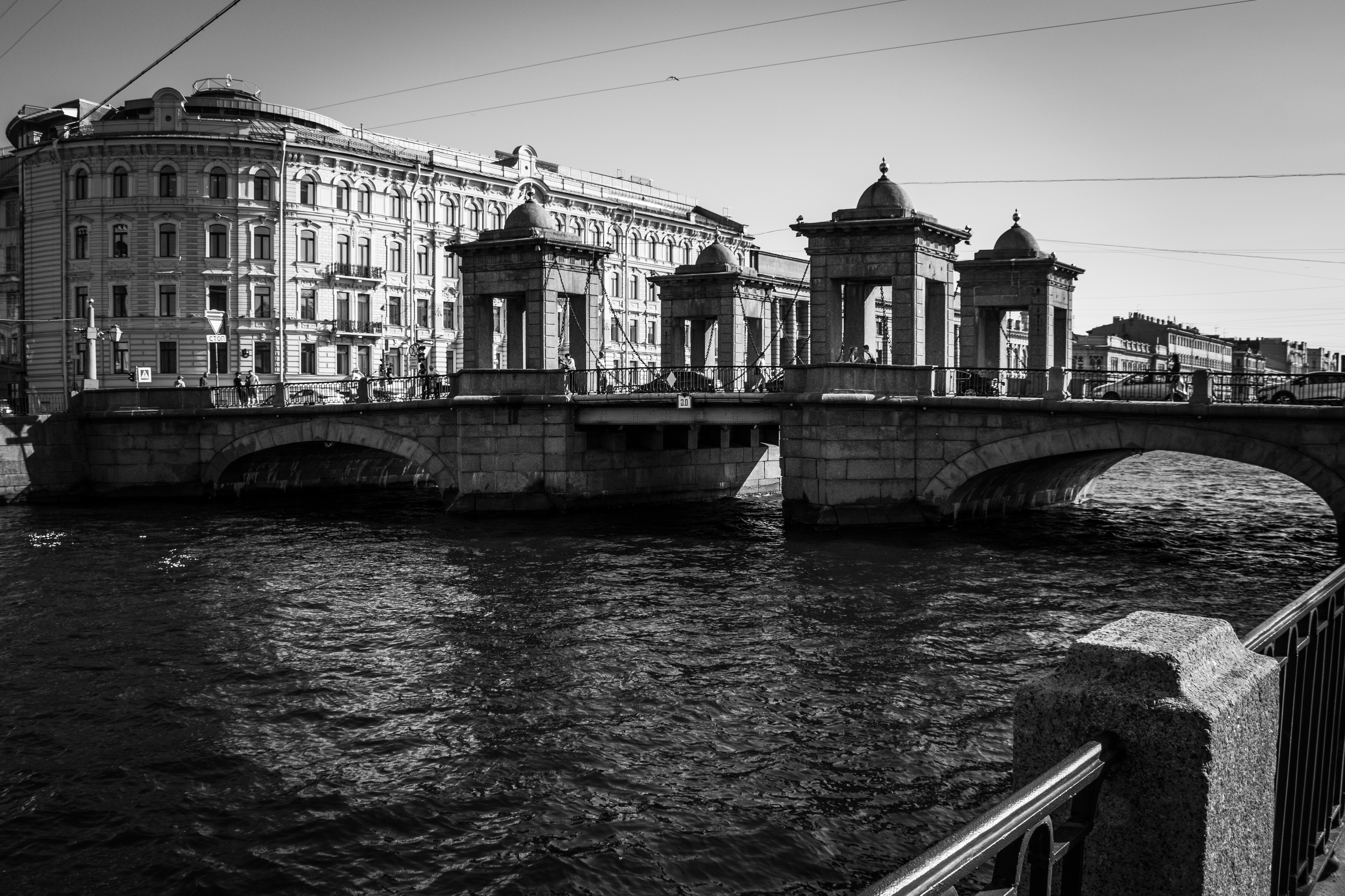 Historic bridge with decorative towers spanning a river.