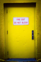 Yellow fire exit door with a red