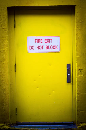 Yellow fire exit door with a red