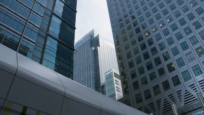 Modern glass and steel skyscrapers with a walkway