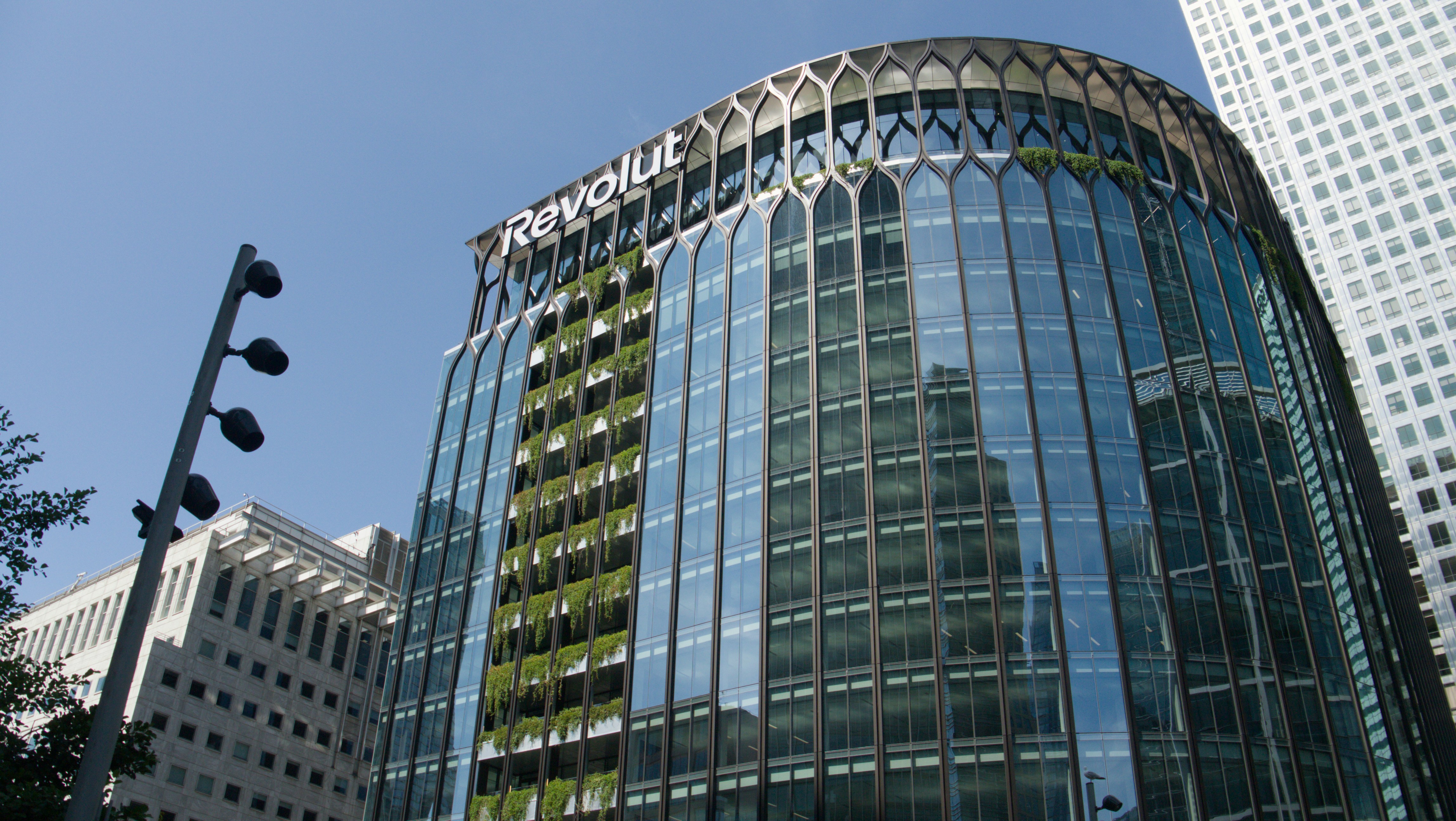 A modern glass building with the revolut logo