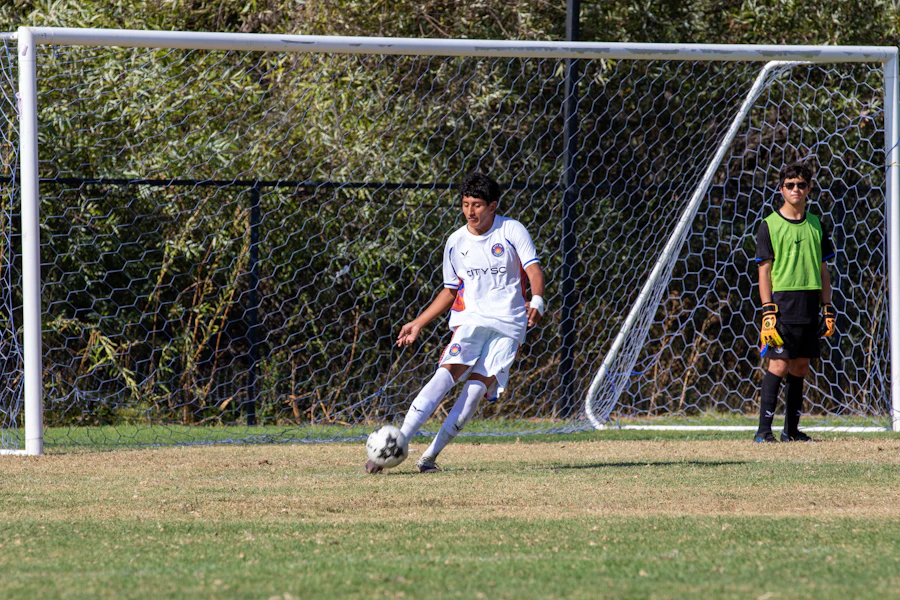 Soccer player competing near the goal