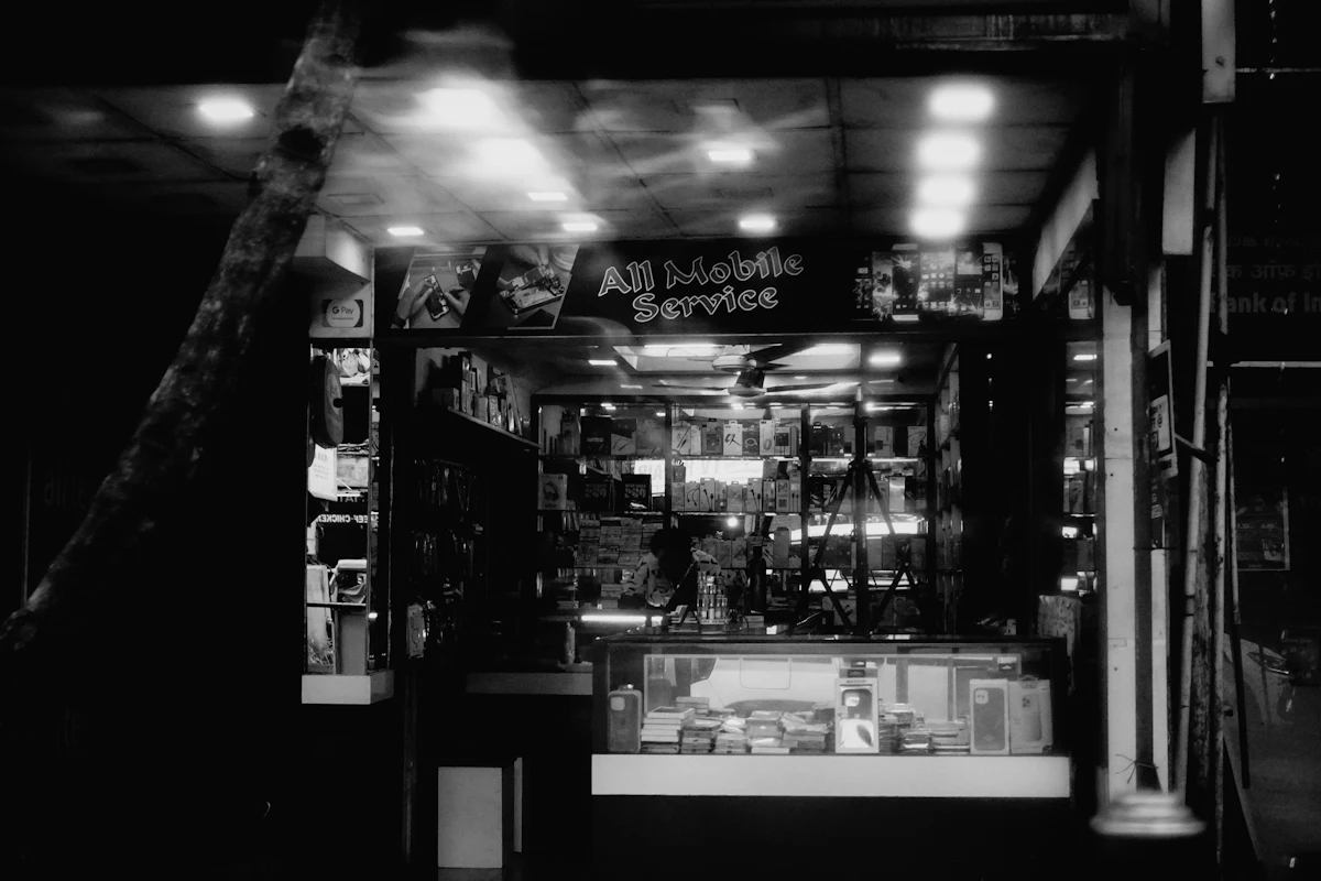 A mobile service shopfront lit up in the evening