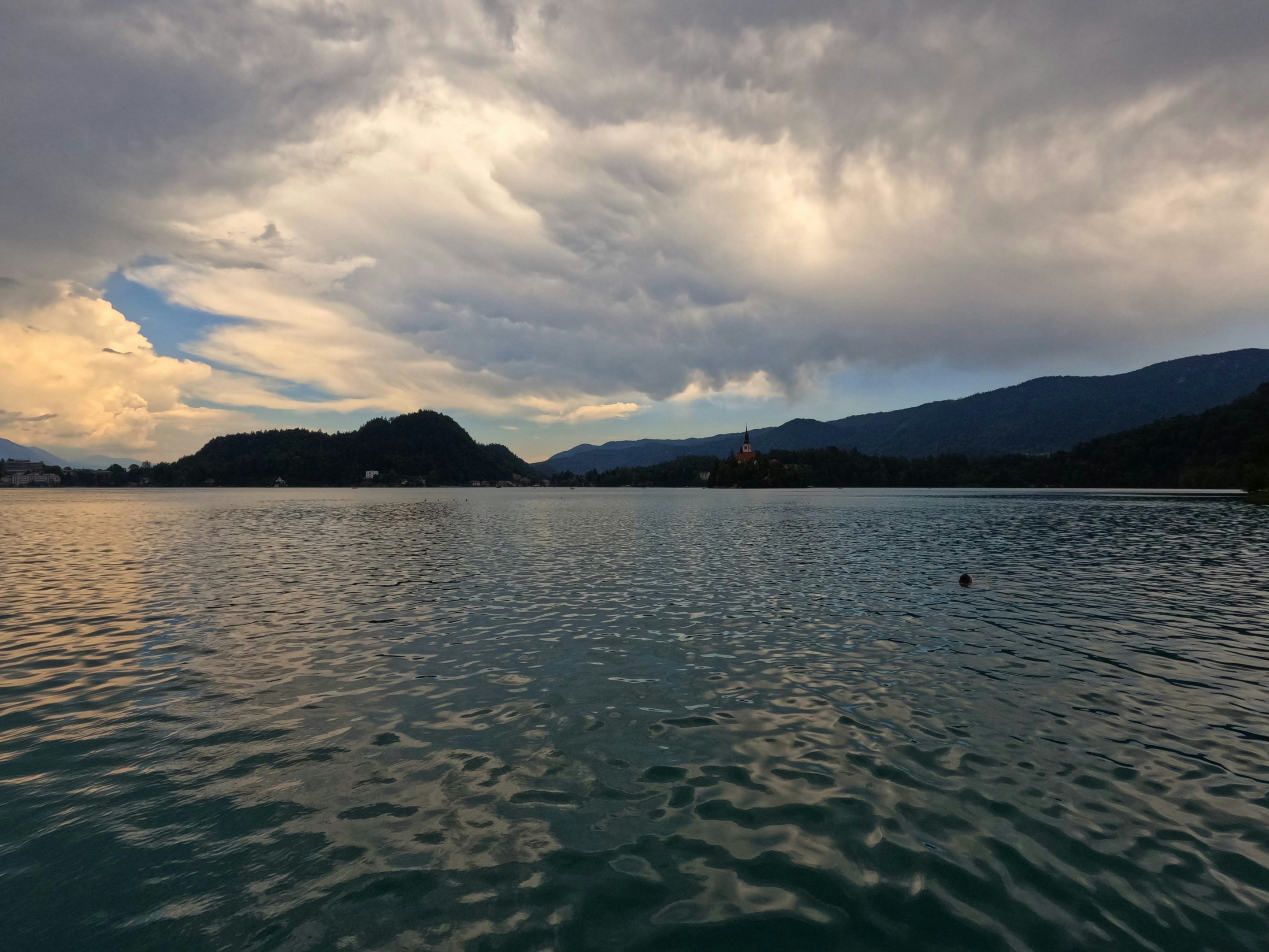 Beautiful lake landscape under a dramatic, cloudy evening sky
