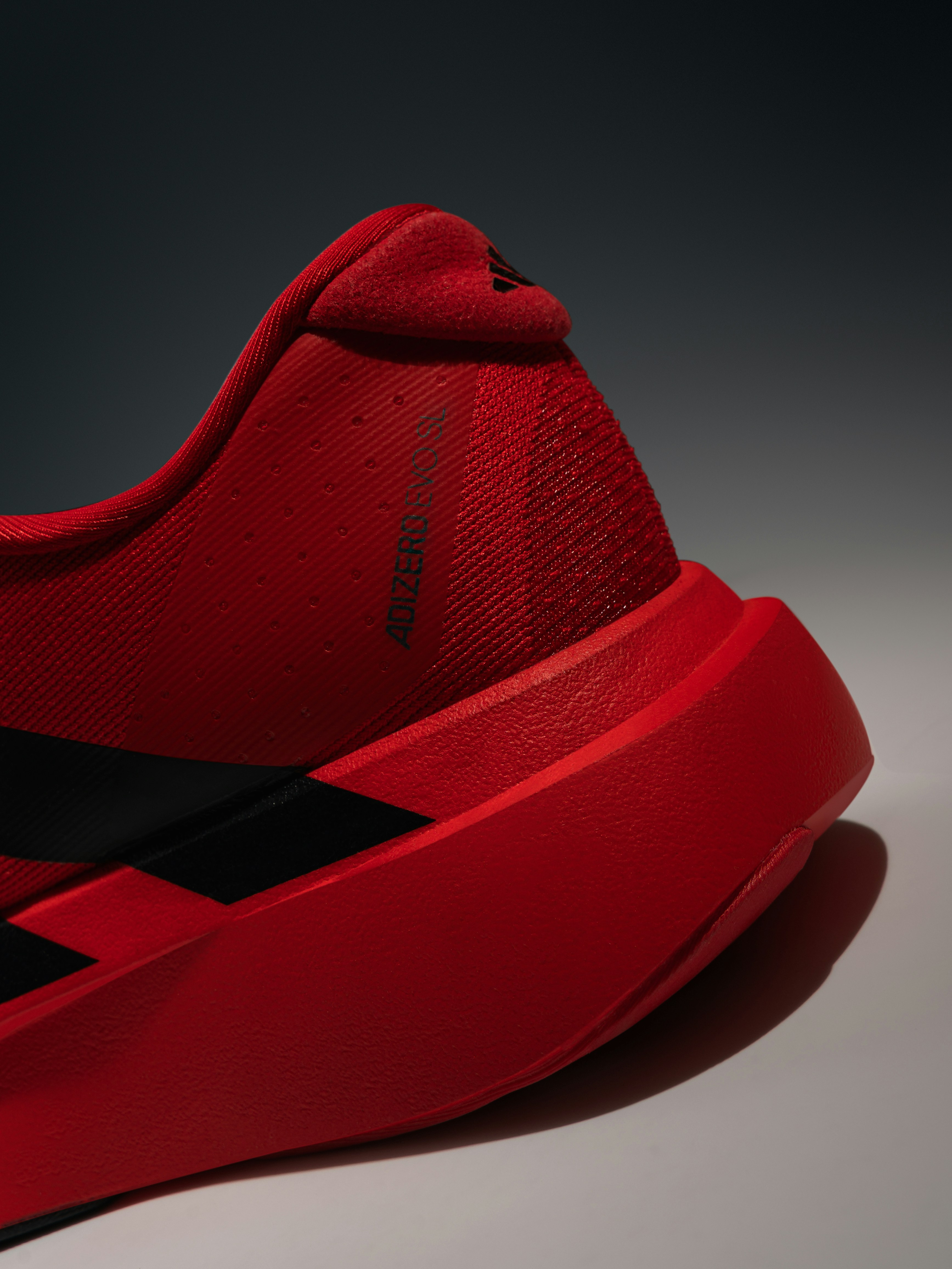 Modern red running shoe with black stripes