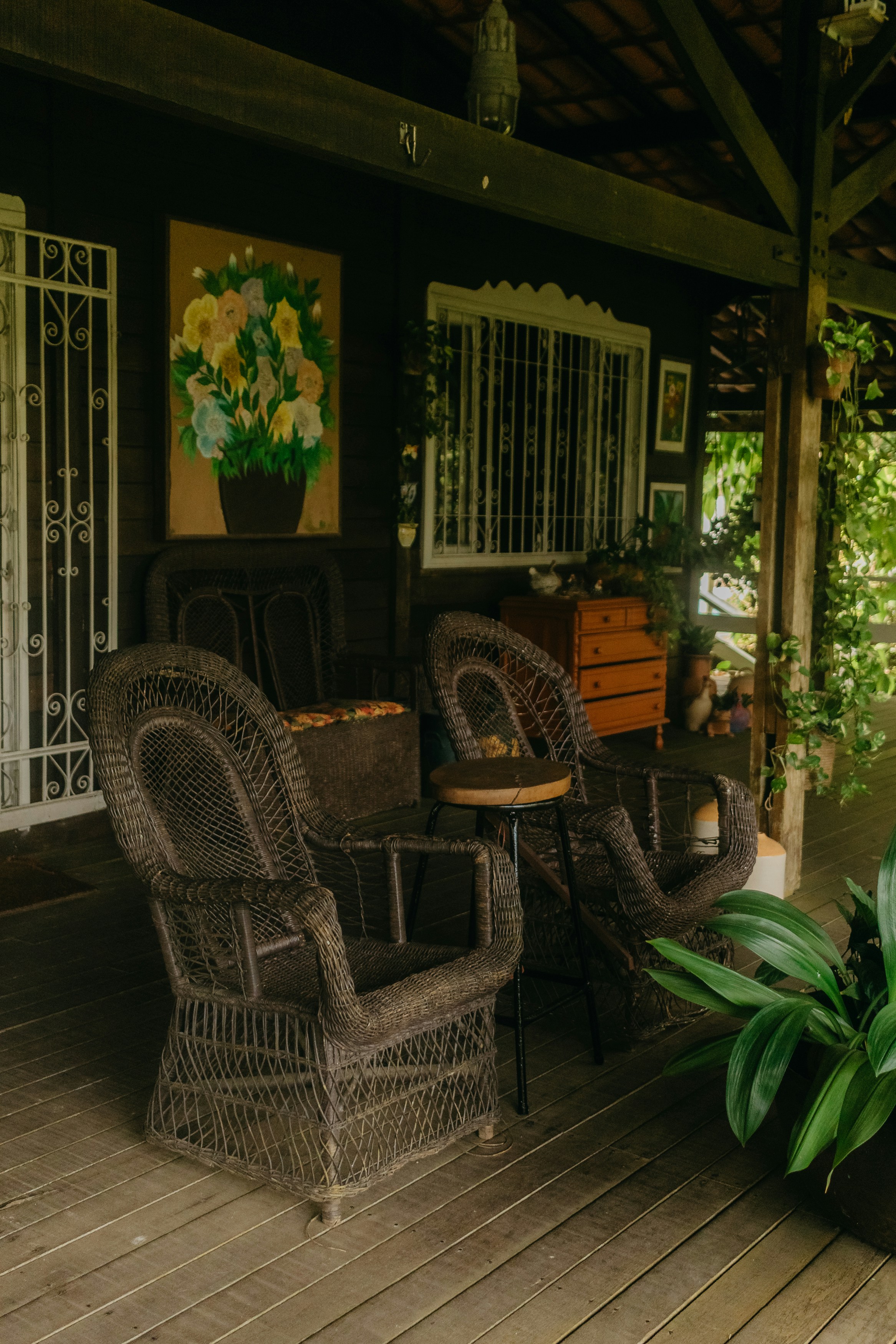Rustic porch with wicker chairs and flower painting
