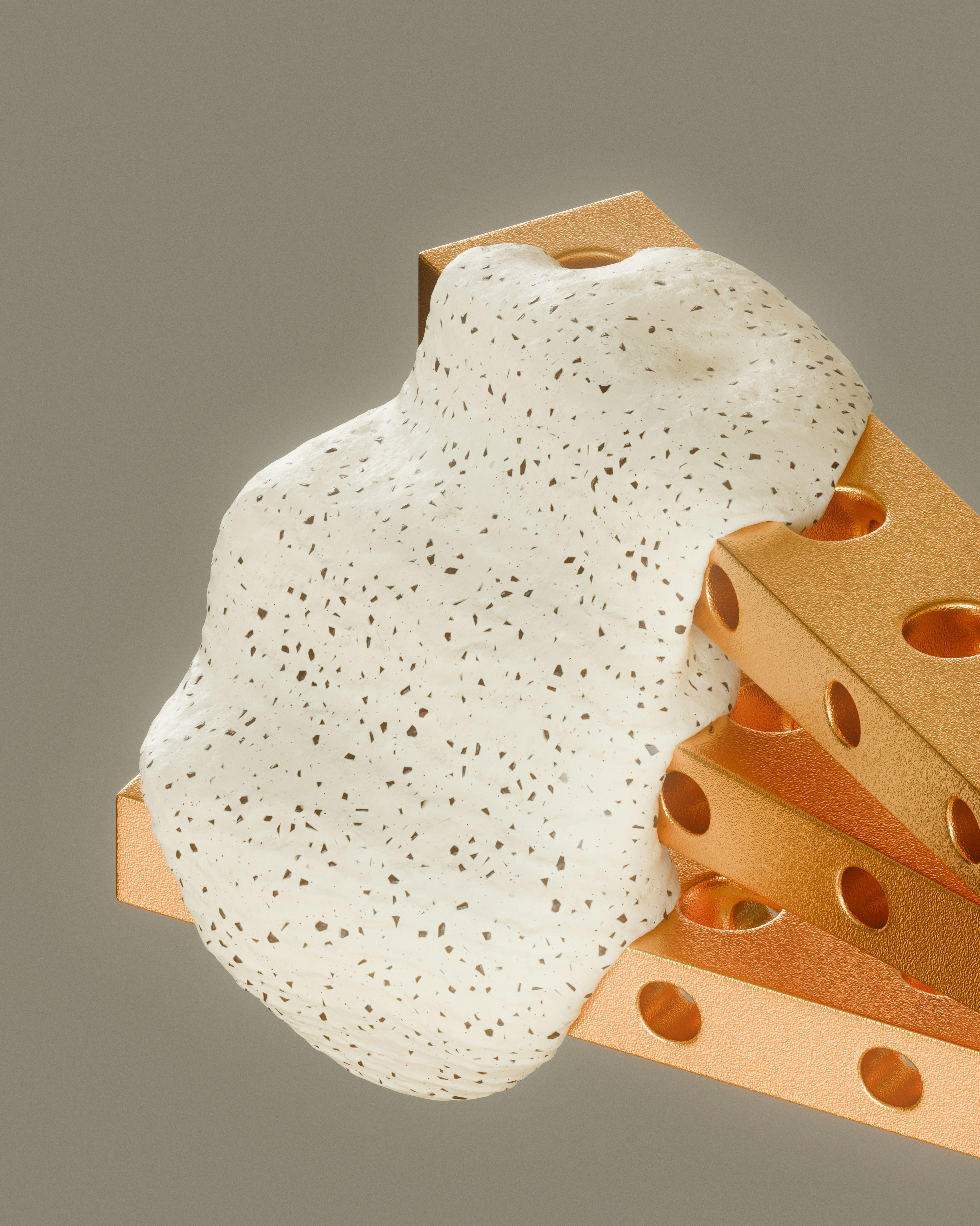 White speckled foam flowing over perforated copper blocks.