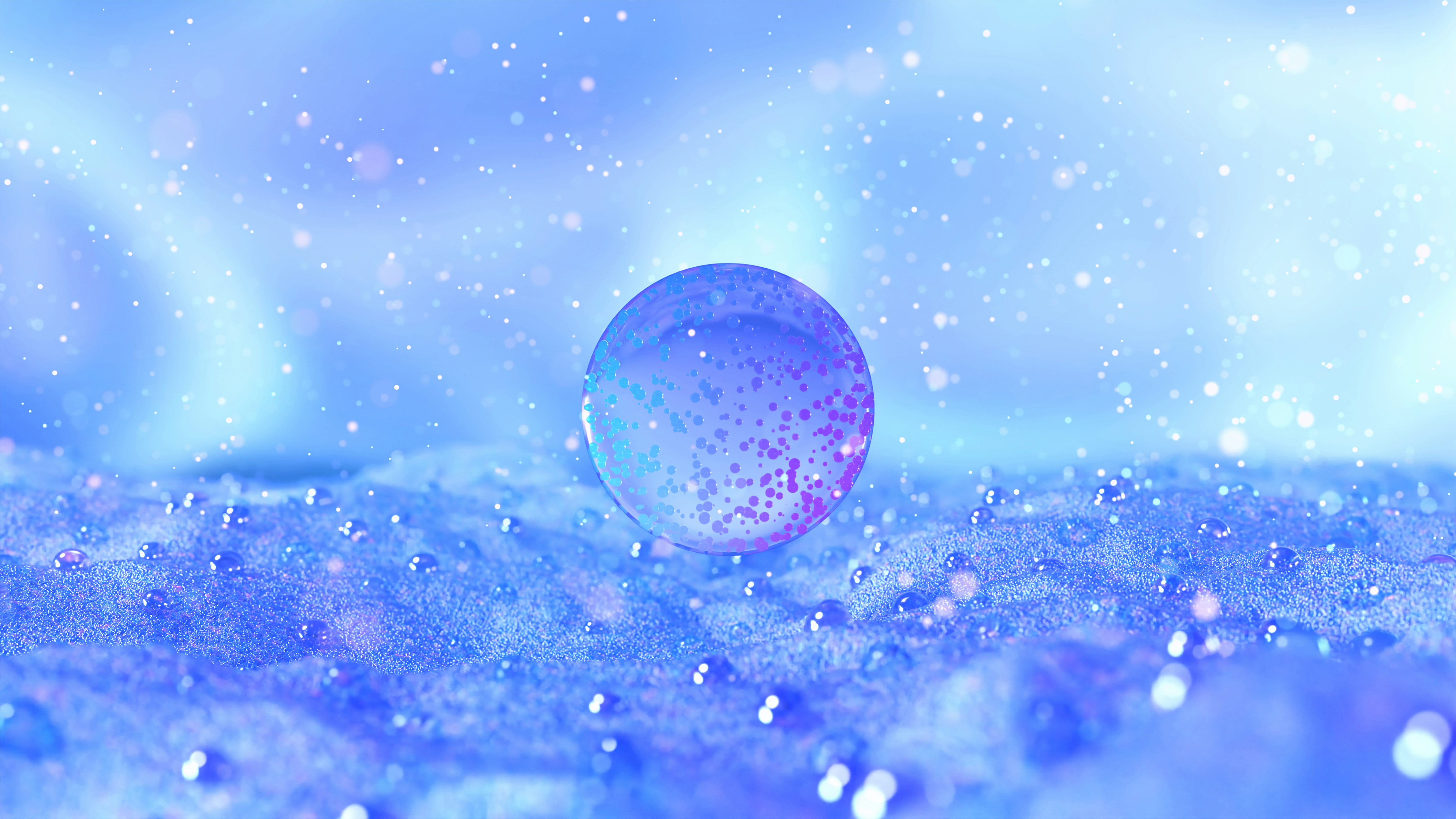 Clear sphere with red glitter on a blue, wet surface