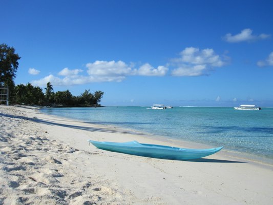Kayak on white sand beach, clear ocean, blue sky — Tahiti & Bora Bora, French Polynesia