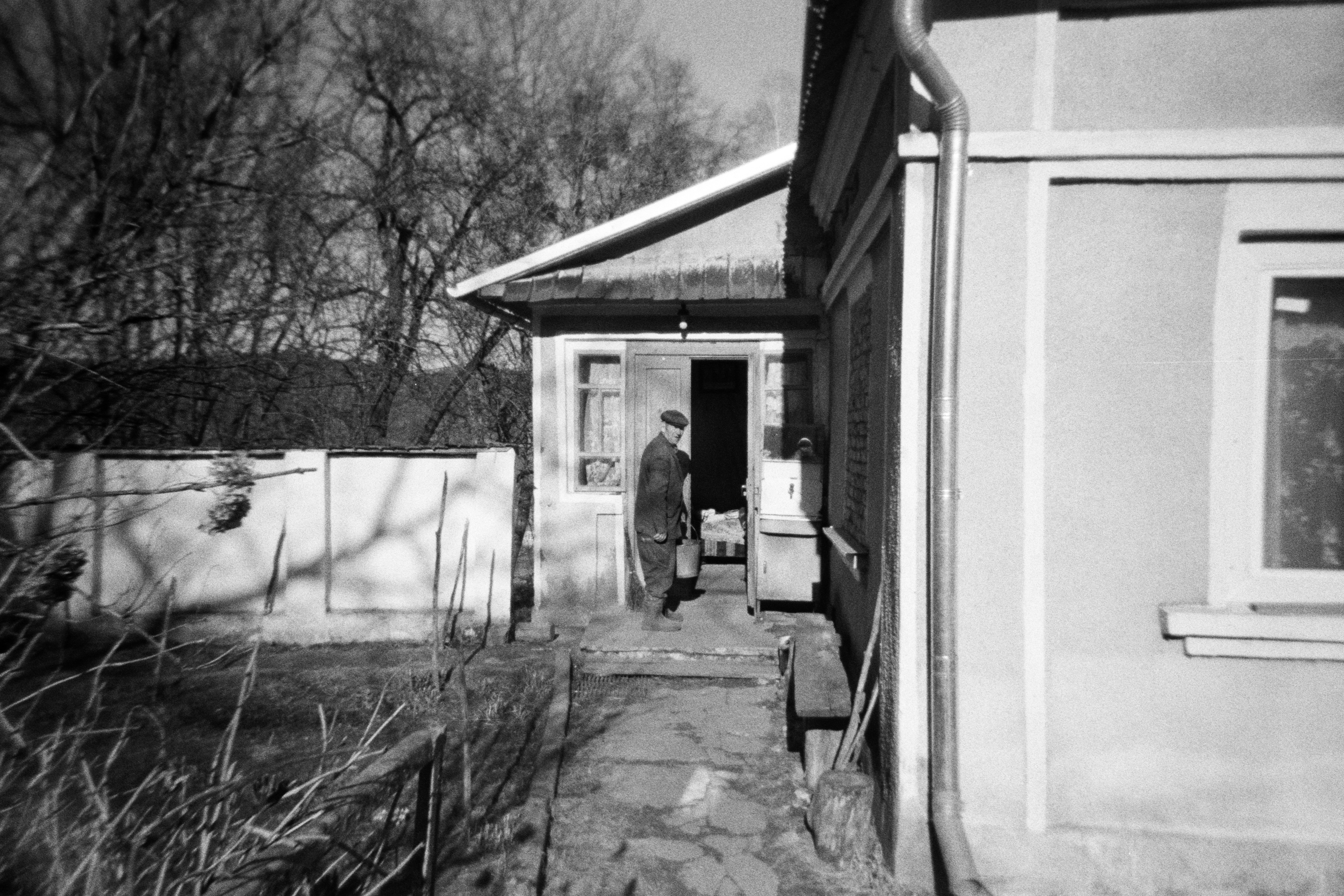 Person standing in an old house's doorway